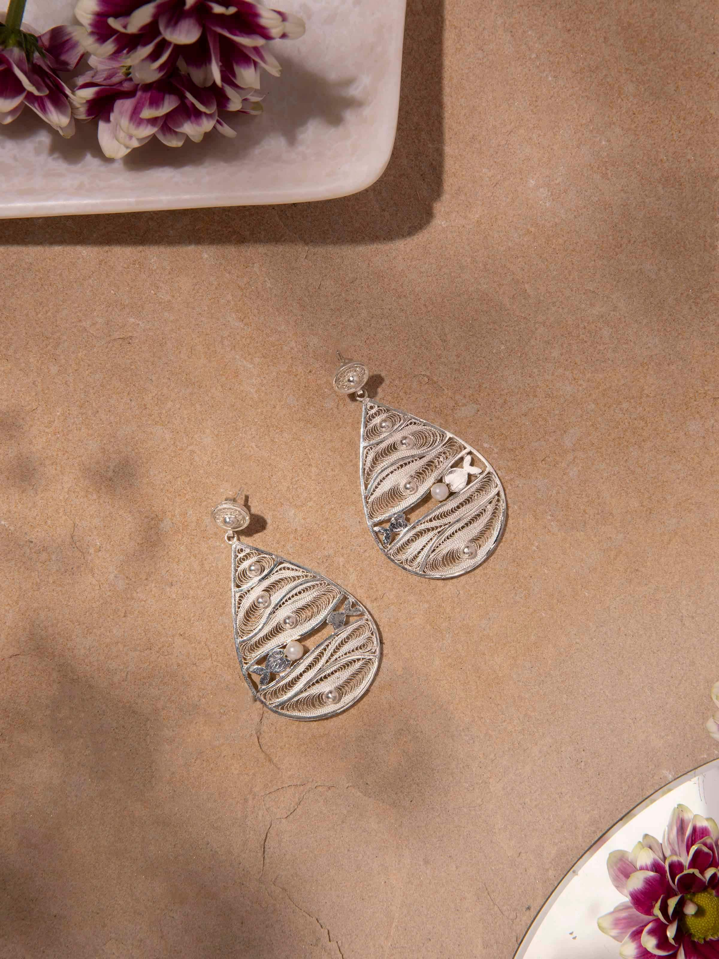 Side view of Silver Filigree Drop Earrings highlighting intricate detailing.