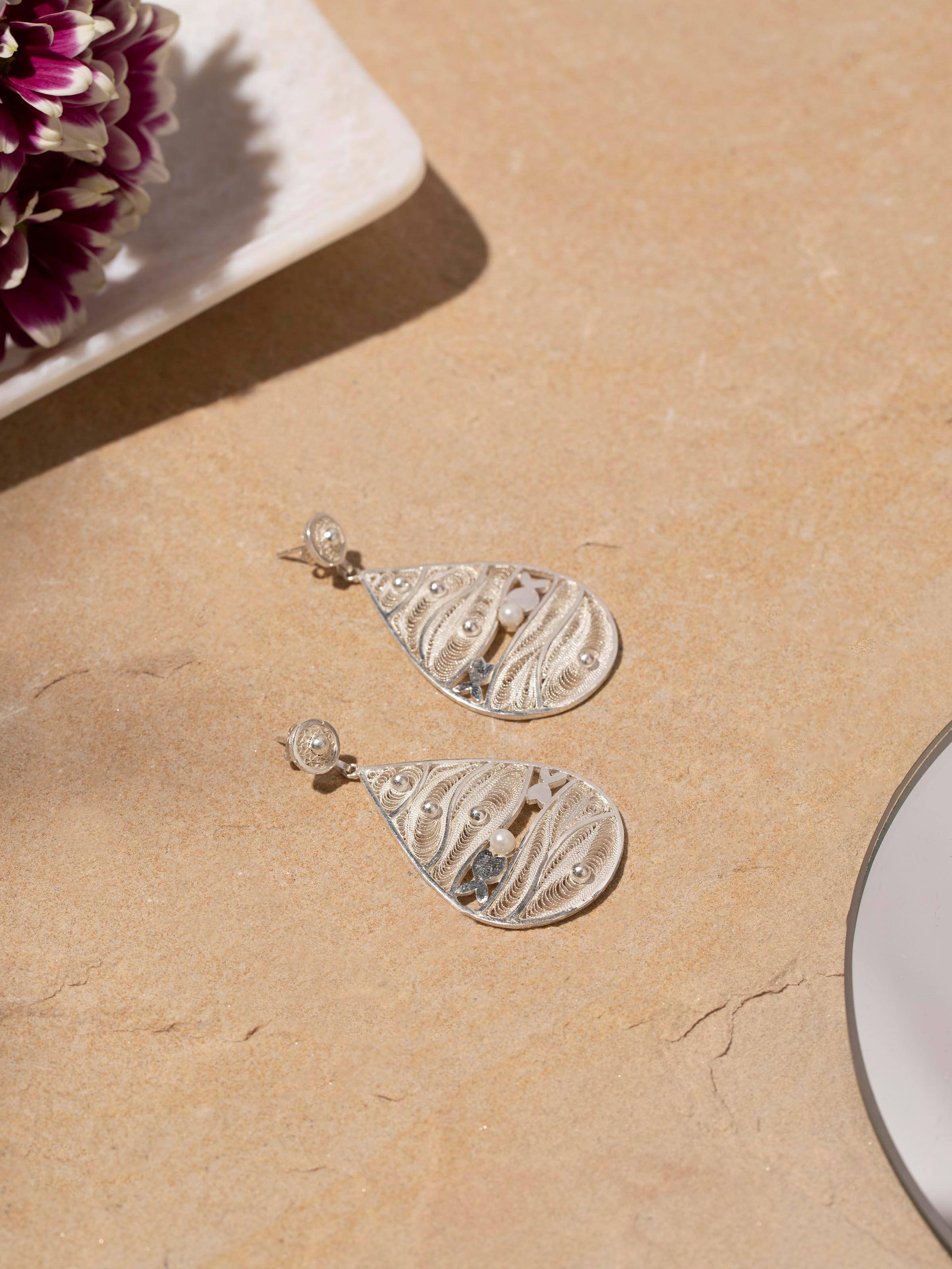 Close-up view of Silver Filigree Drop Earrings emphasizing fine craftsmanship.