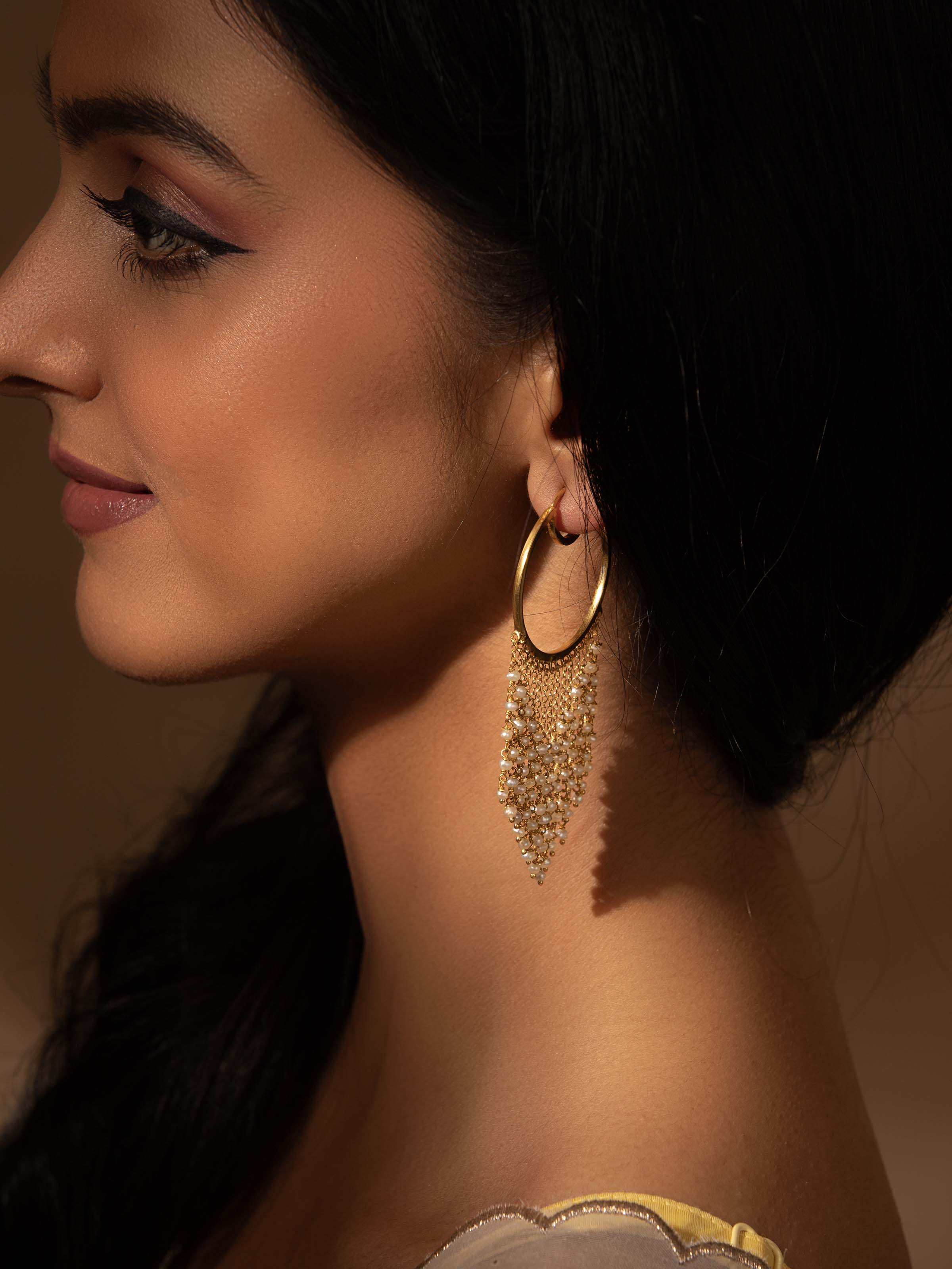 Close-up view of silver smithing hoops showcasing detailed design and craftsmanship