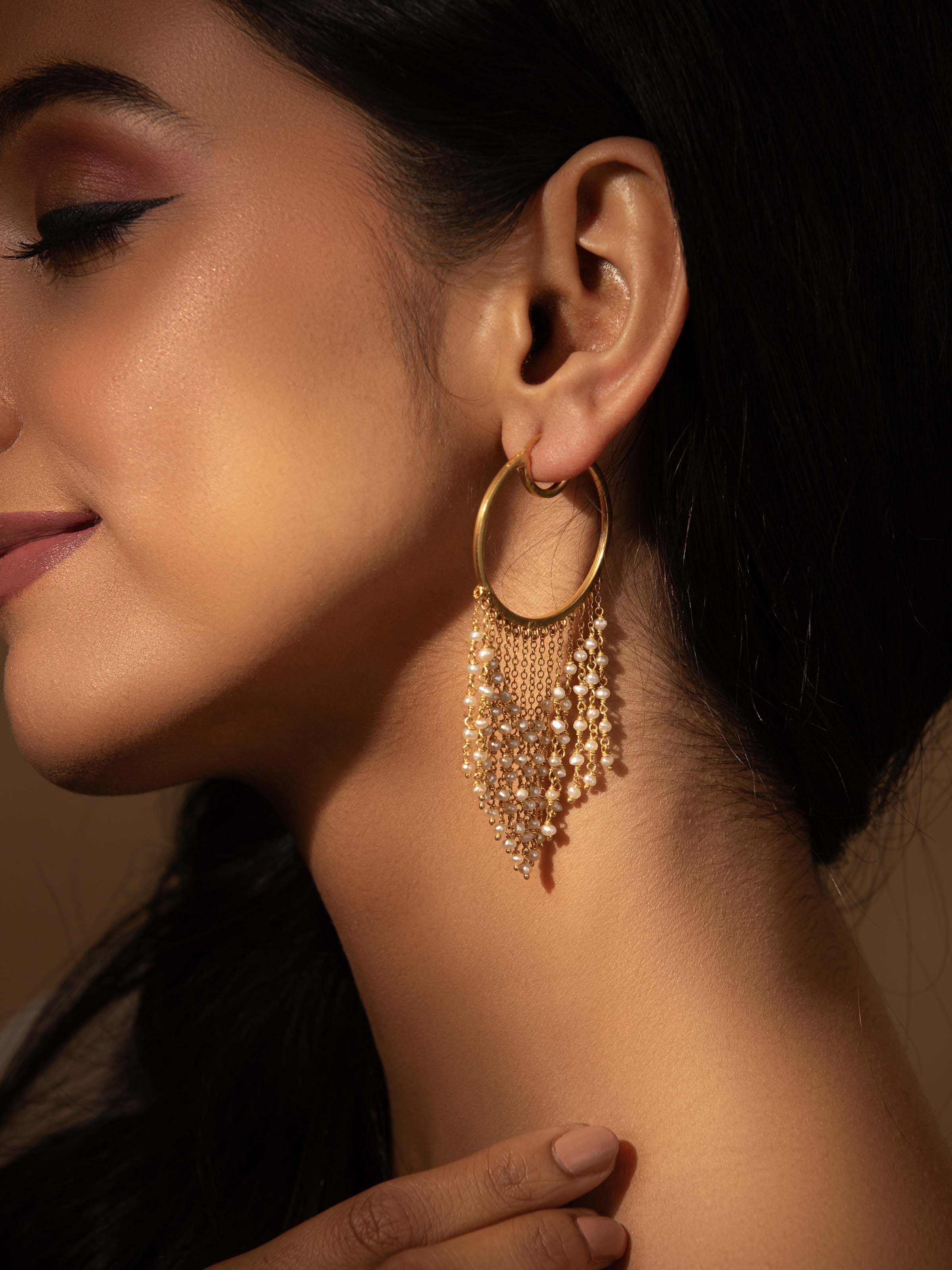 Side view of silver smithing hoops displaying their elegant shape and finish