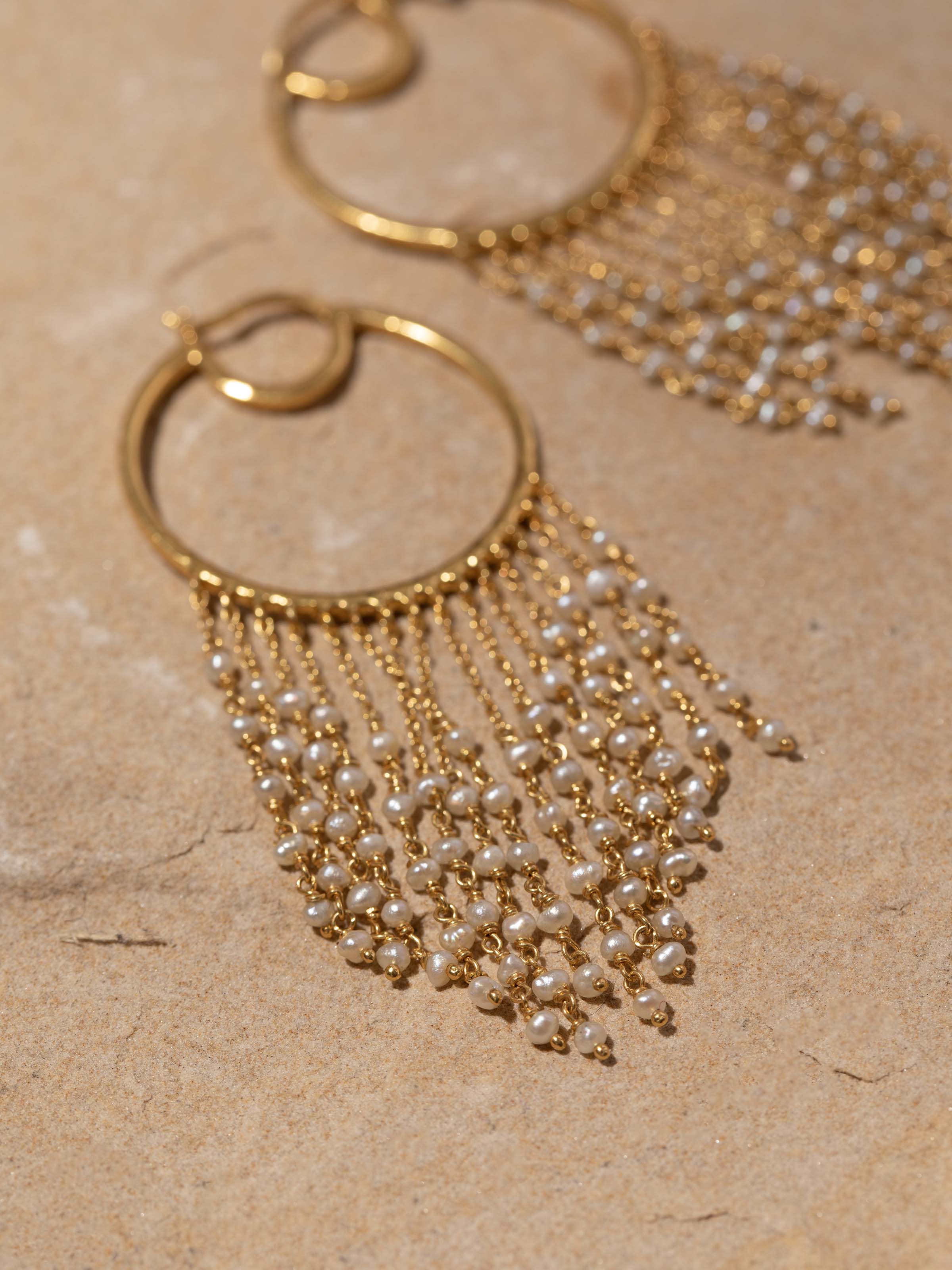 Detailed close-up of silver smithing hoops focusing on their design and texture