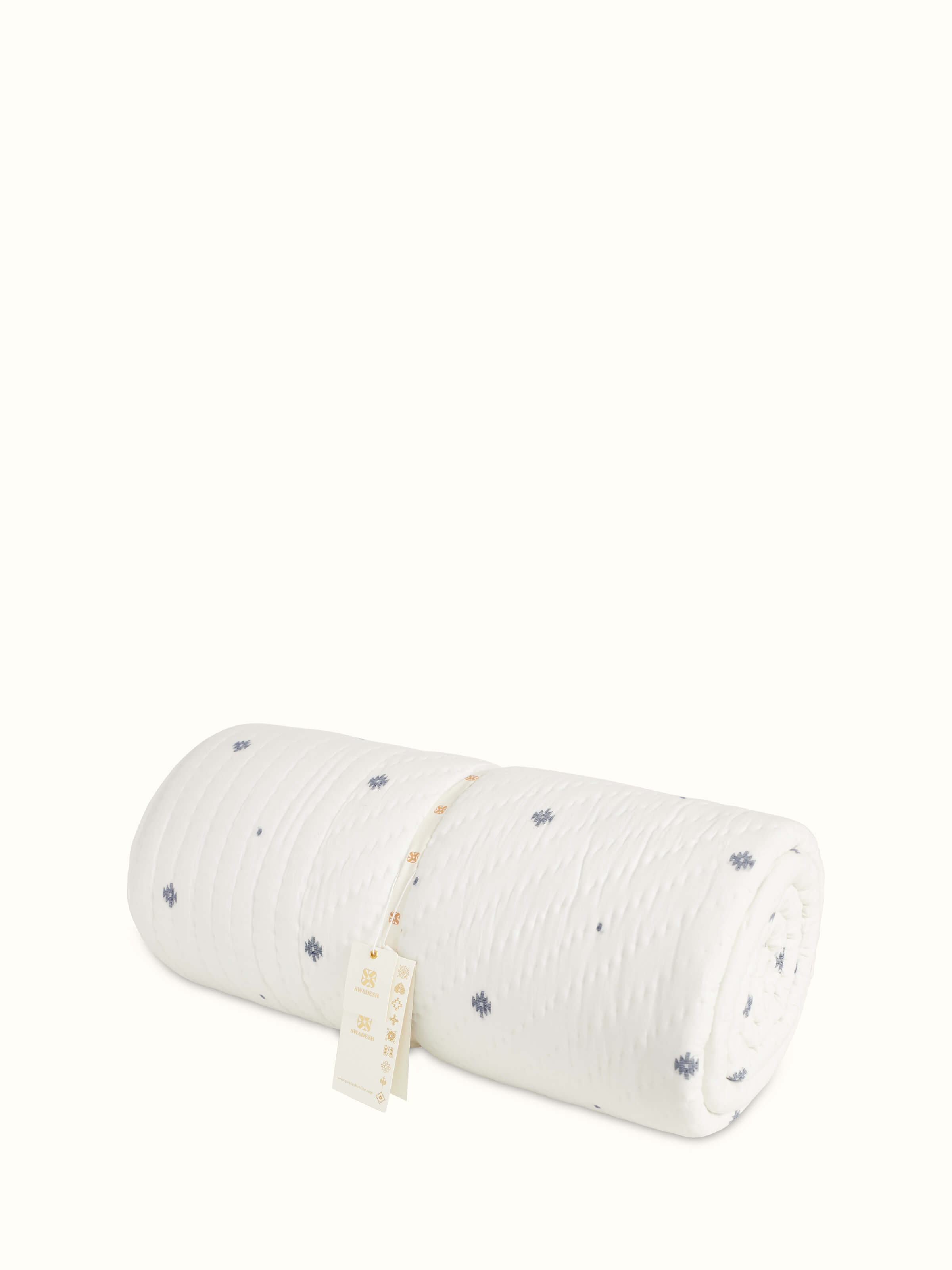 Detailed view of Kalpanama ivory woven buti cotton quilt double, highlighting the texture and craftsmanship.