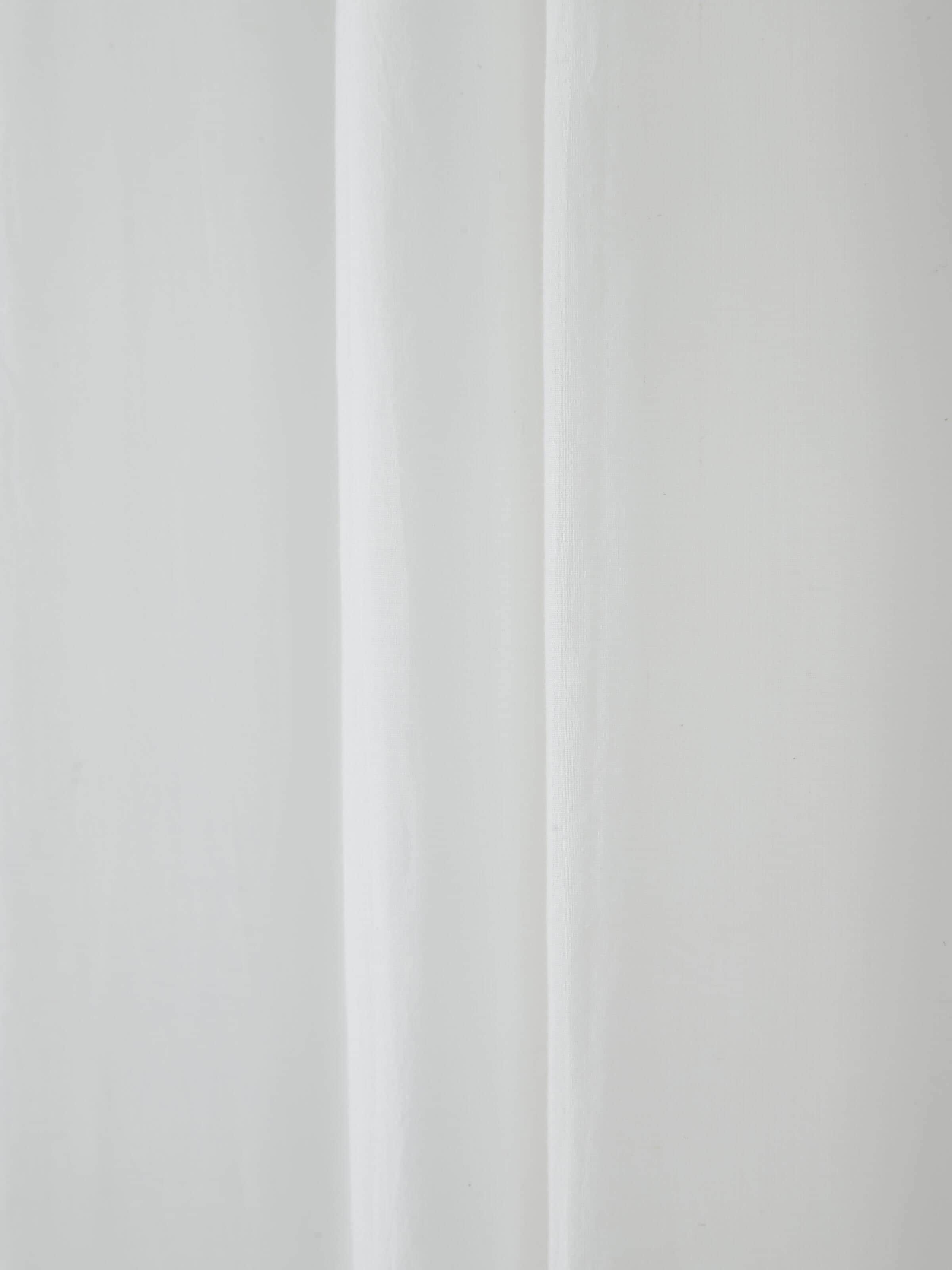 Side view of Kalpanama ivory solid handloom cotton curtain (9 ft) emphasizing the curtain's drape and texture.