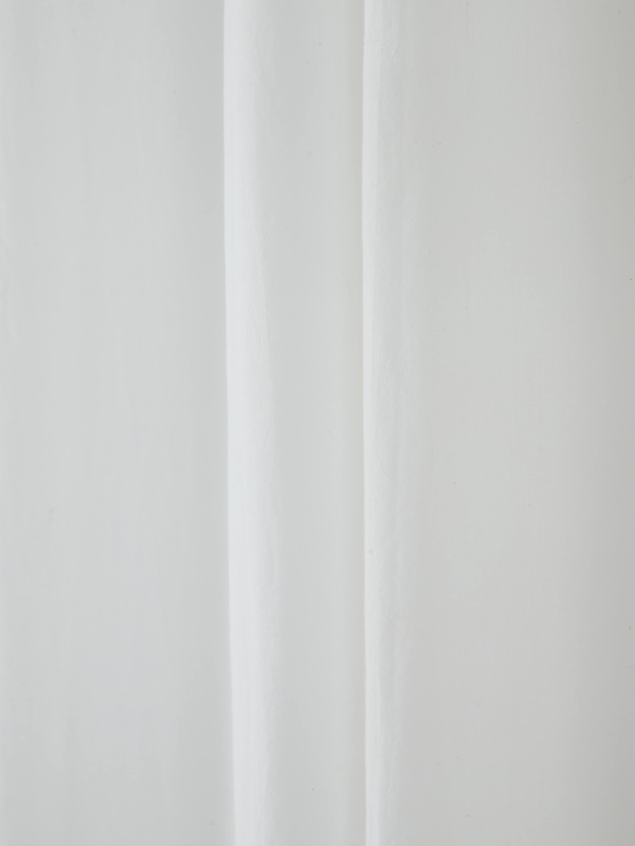 Detailed view of ivory solid handloom cotton curtain (7 ft), showing the curtain's texture and finish.