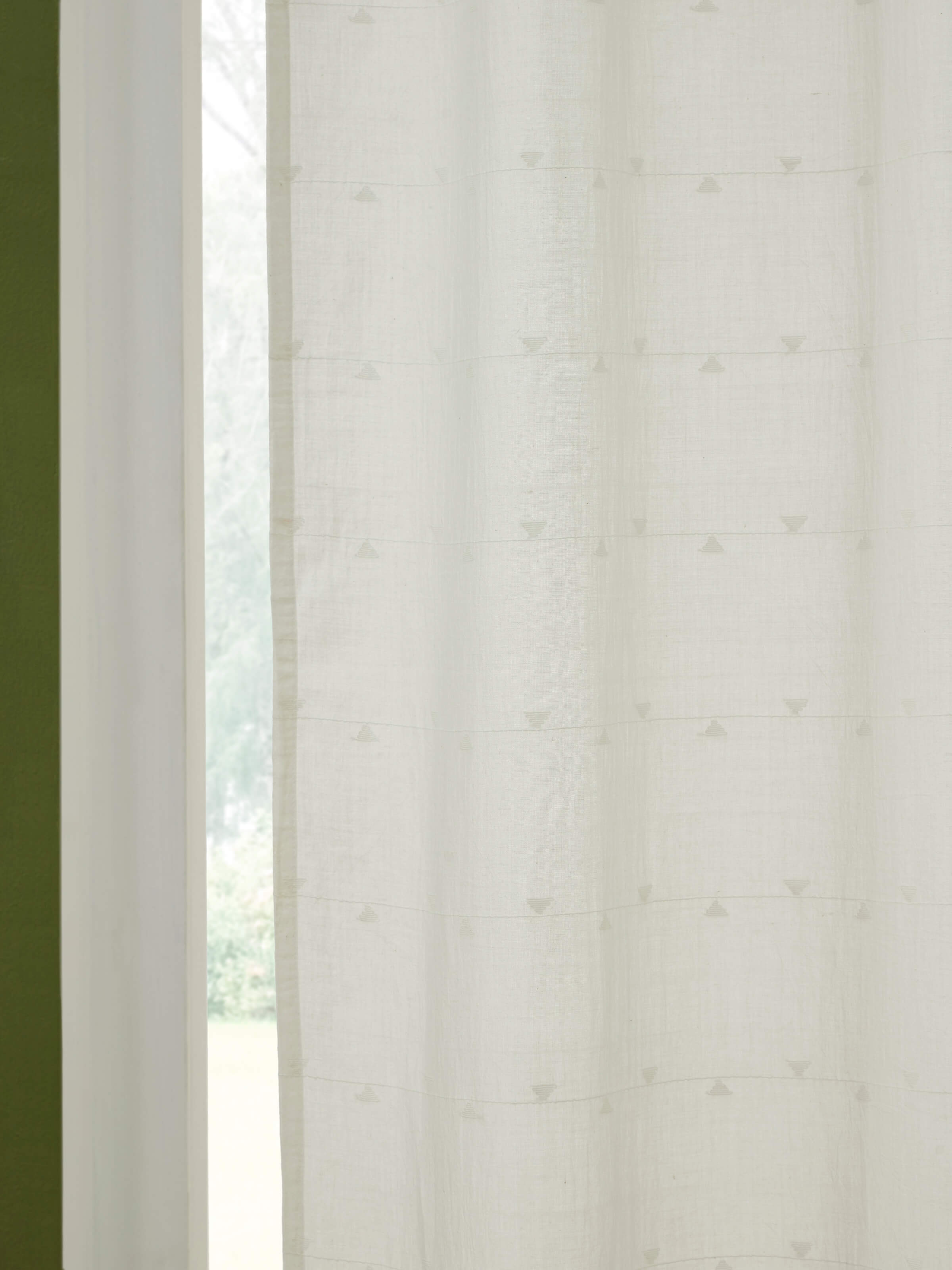 Artistic view of Kalpanama white woven buti handloom cotton curtain, highlighting the fabric drape