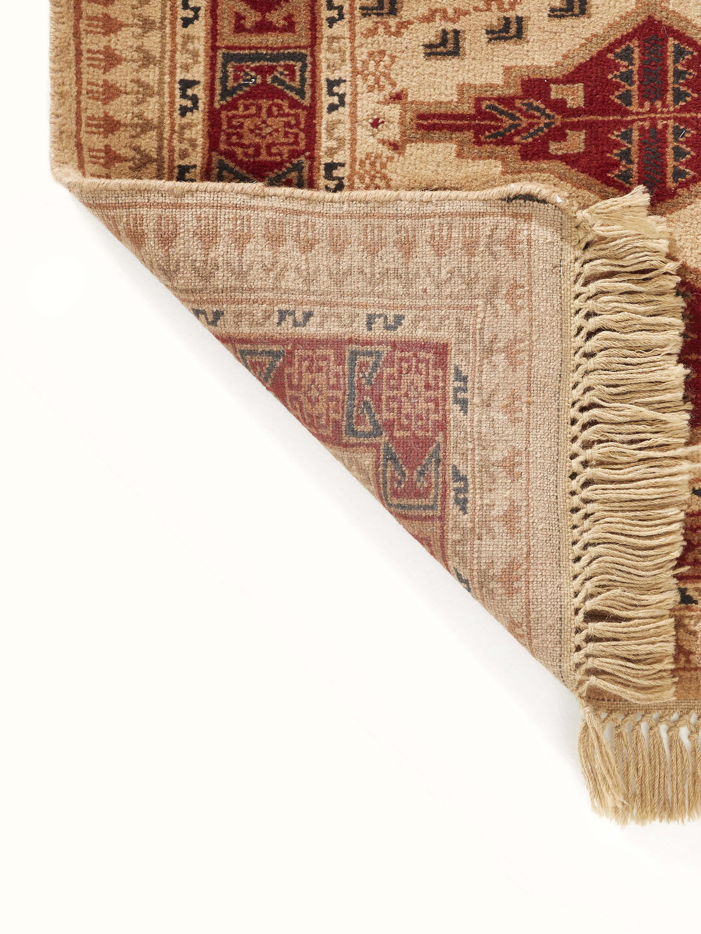 Angled view of Traditional Persian Shiraz Beige Rust Gwalior Wool Hand-Knotted Runner showing the pattern in context