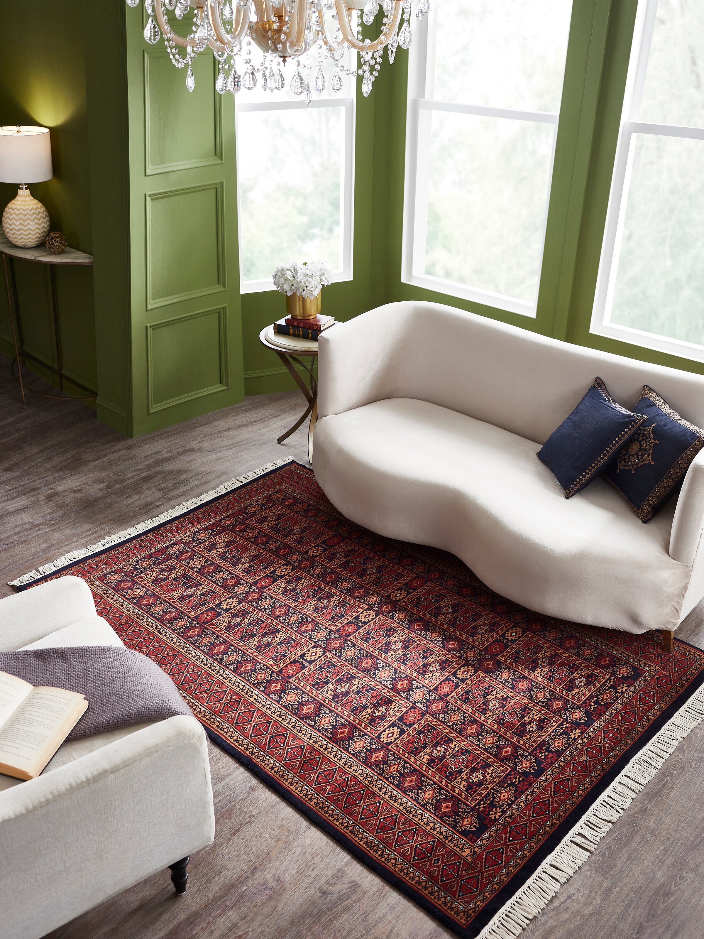 Lifestyle view of red Gwalior wool hand-knotted rug featuring traditional Bukhara motifs and soft pile