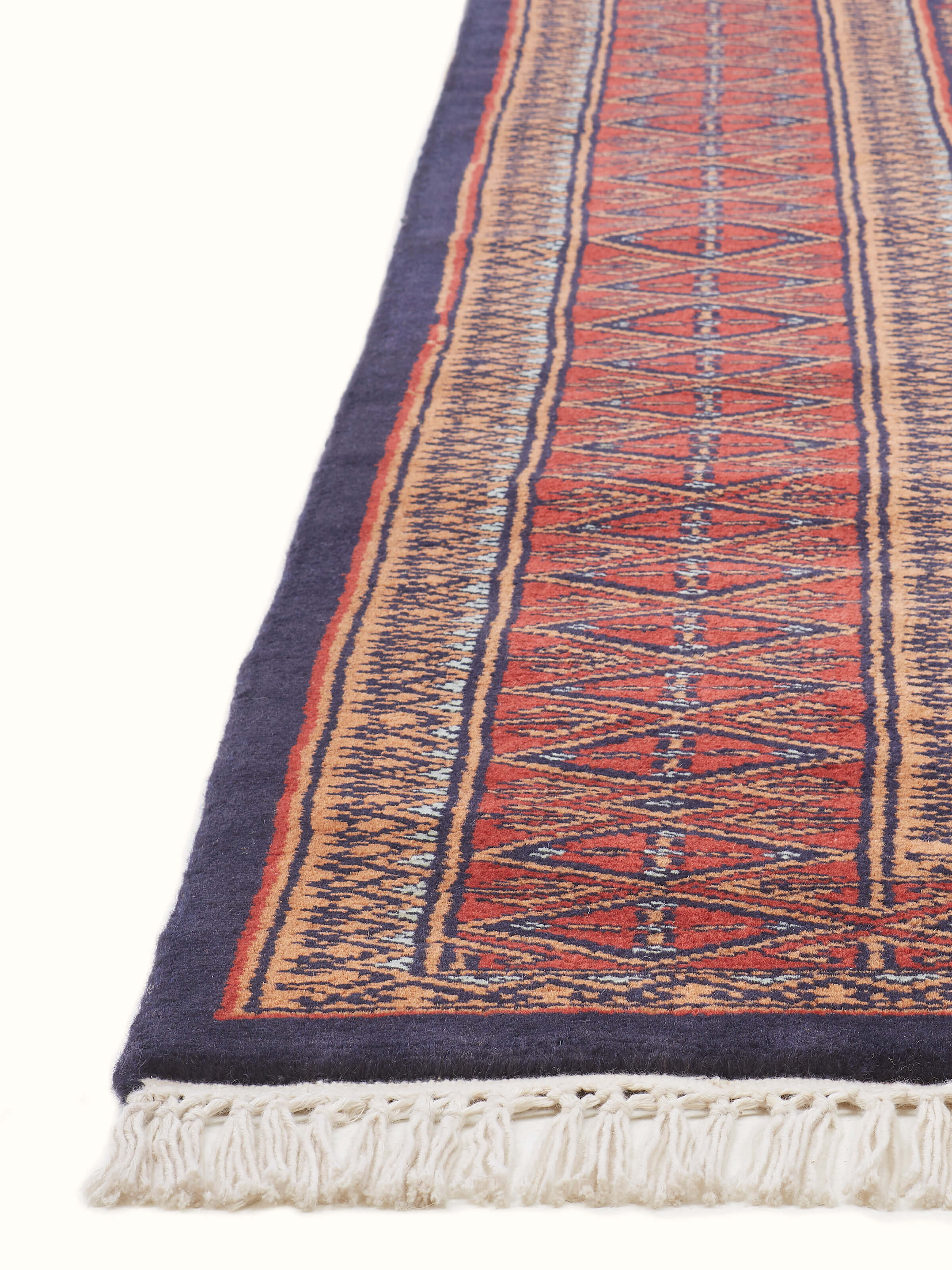Close-up of Traditional Bukhara Red Gwalior Wool Hand-Knotted Rug emphasizing the fine wool texture and traditional design elements.