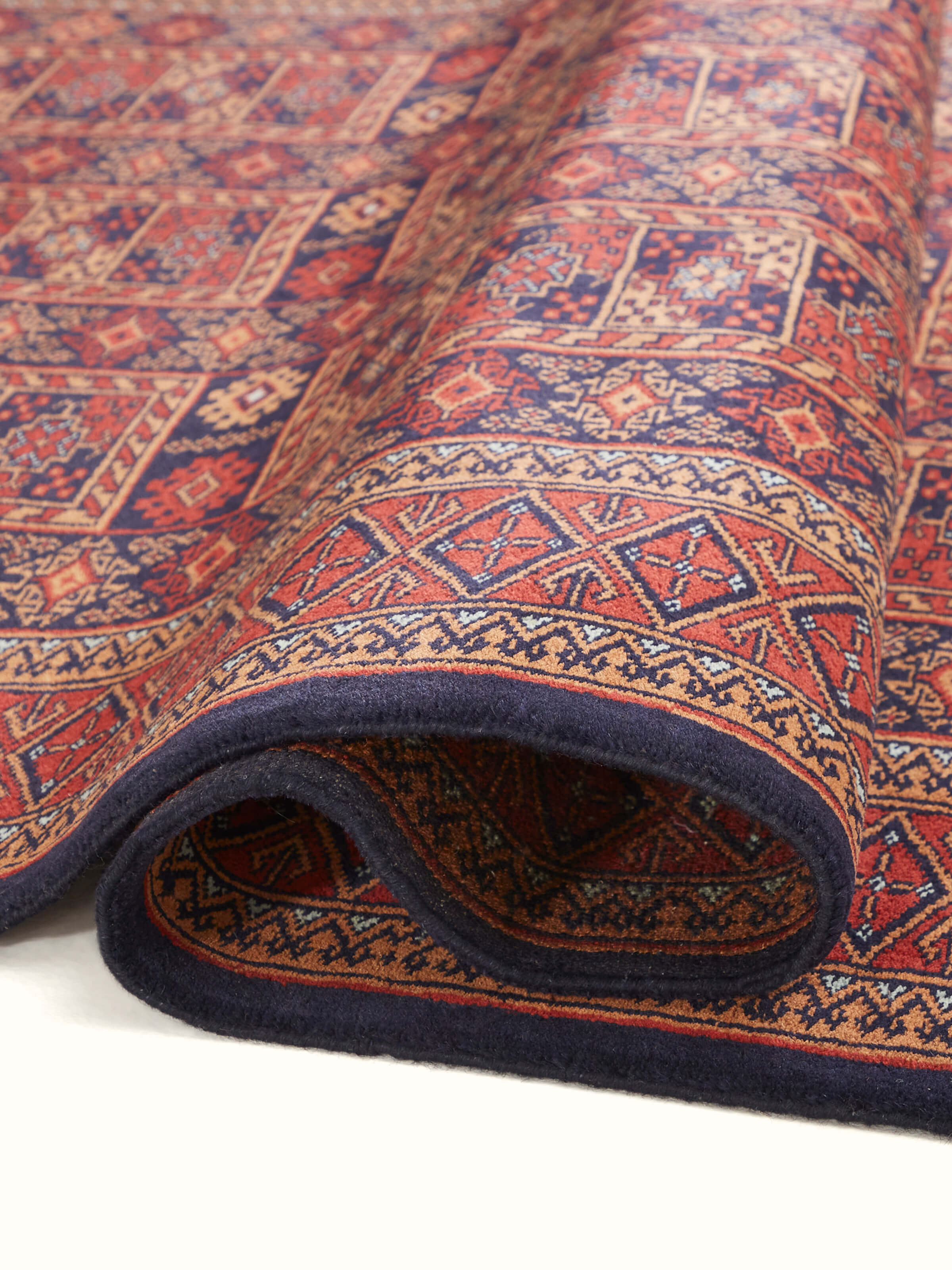 Detailed shot of Traditional Bukhara Red Gwalior Wool Hand-Knotted Rug capturing the depth of color and craftsmanship of the hand-knotted rug.
