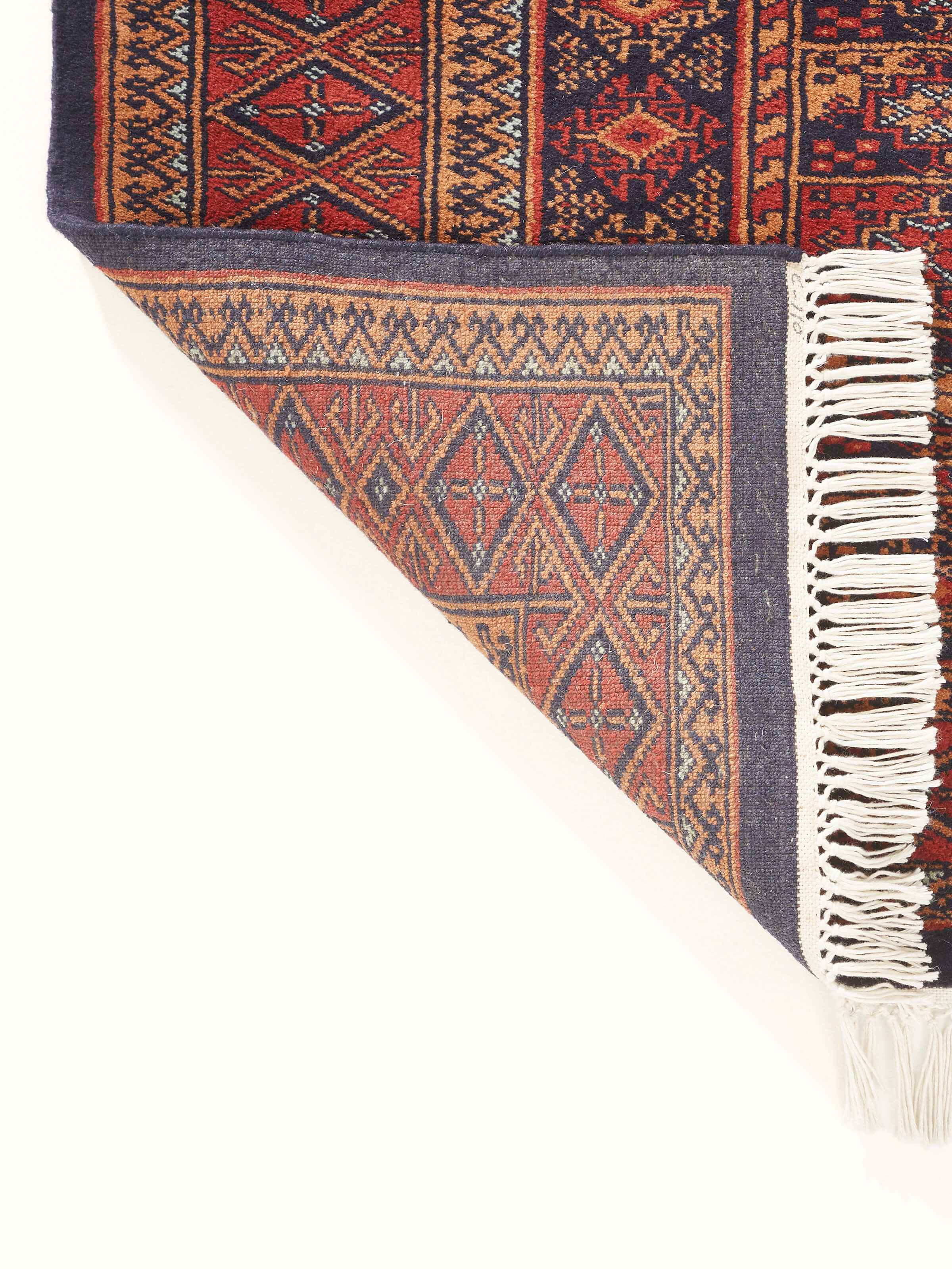 Back side view of Traditional Bukhara Red Gwalior Wool Hand-Knotted Rug emphasizing the fine wool texture and traditional design elements.