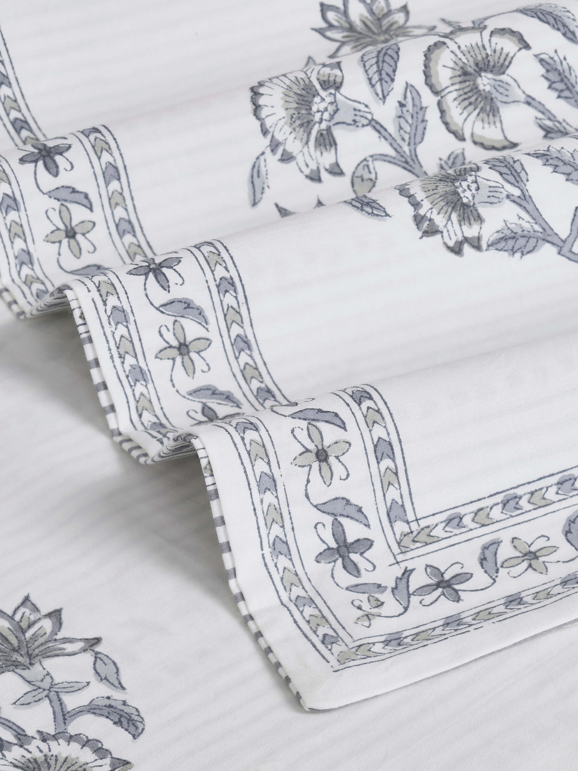 Overhead view of Aarunya grey buta cotton Sanganeri block printed bedsheet showing its full design and print pattern