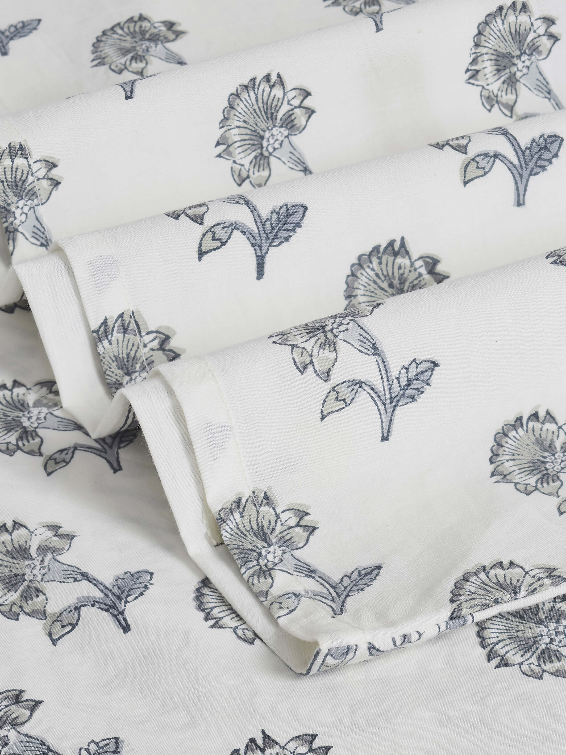 Close-up of Aarunya grey floral cotton Sanganeri block printed king bedsheet set highlighting the intricate block printing on the fabric