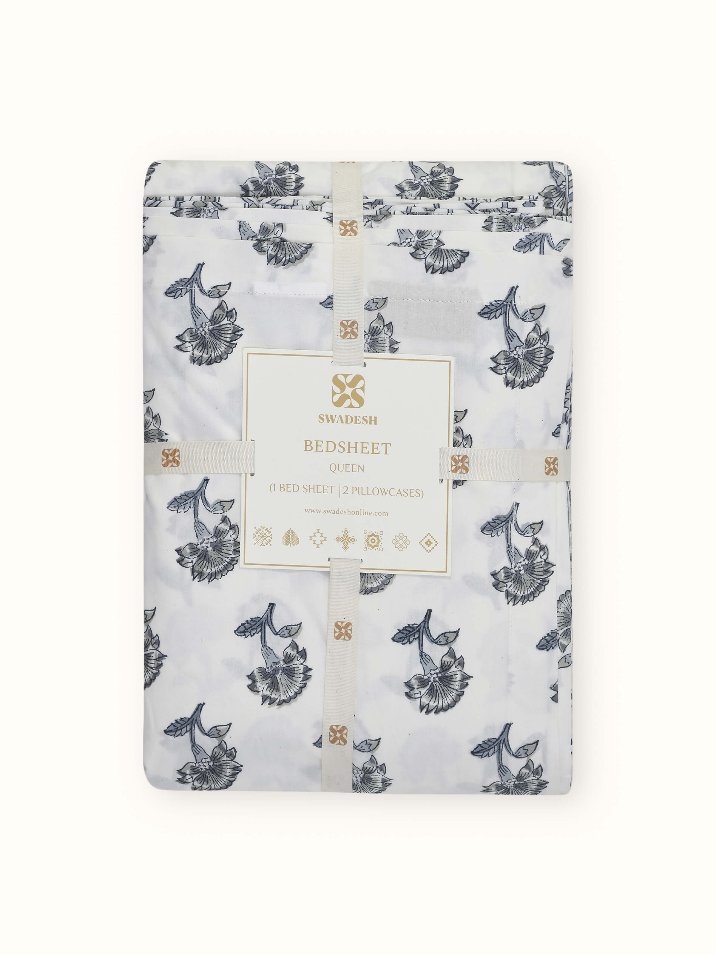 Aarunya grey floral cotton Sanganeri block printed queen bedsheet set with matching pillow covers displayed on a bed.