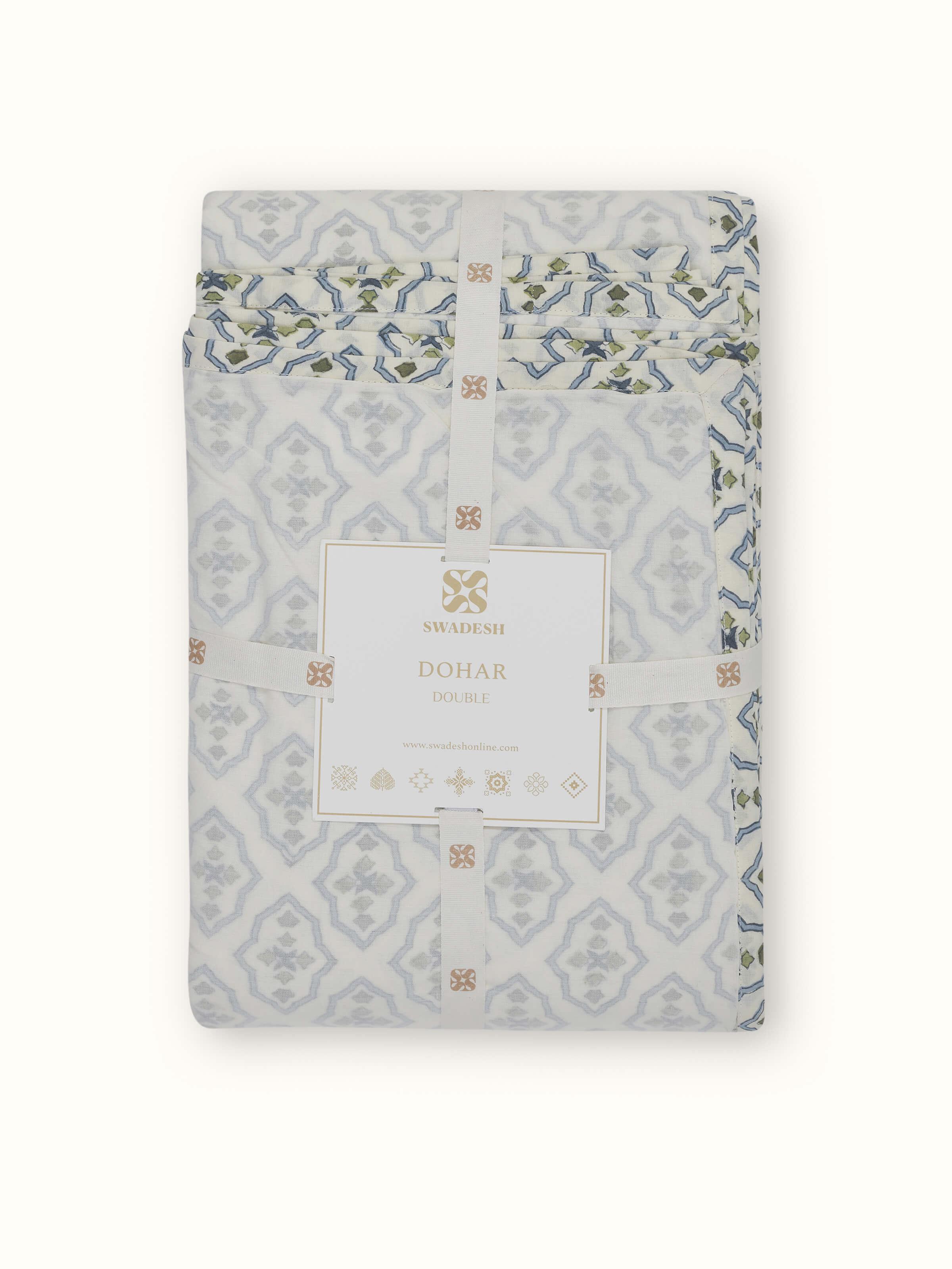 Close-up of Aarunya blue trellis cotton double dohar with focus on the Sanganeri block print and fabric texture.