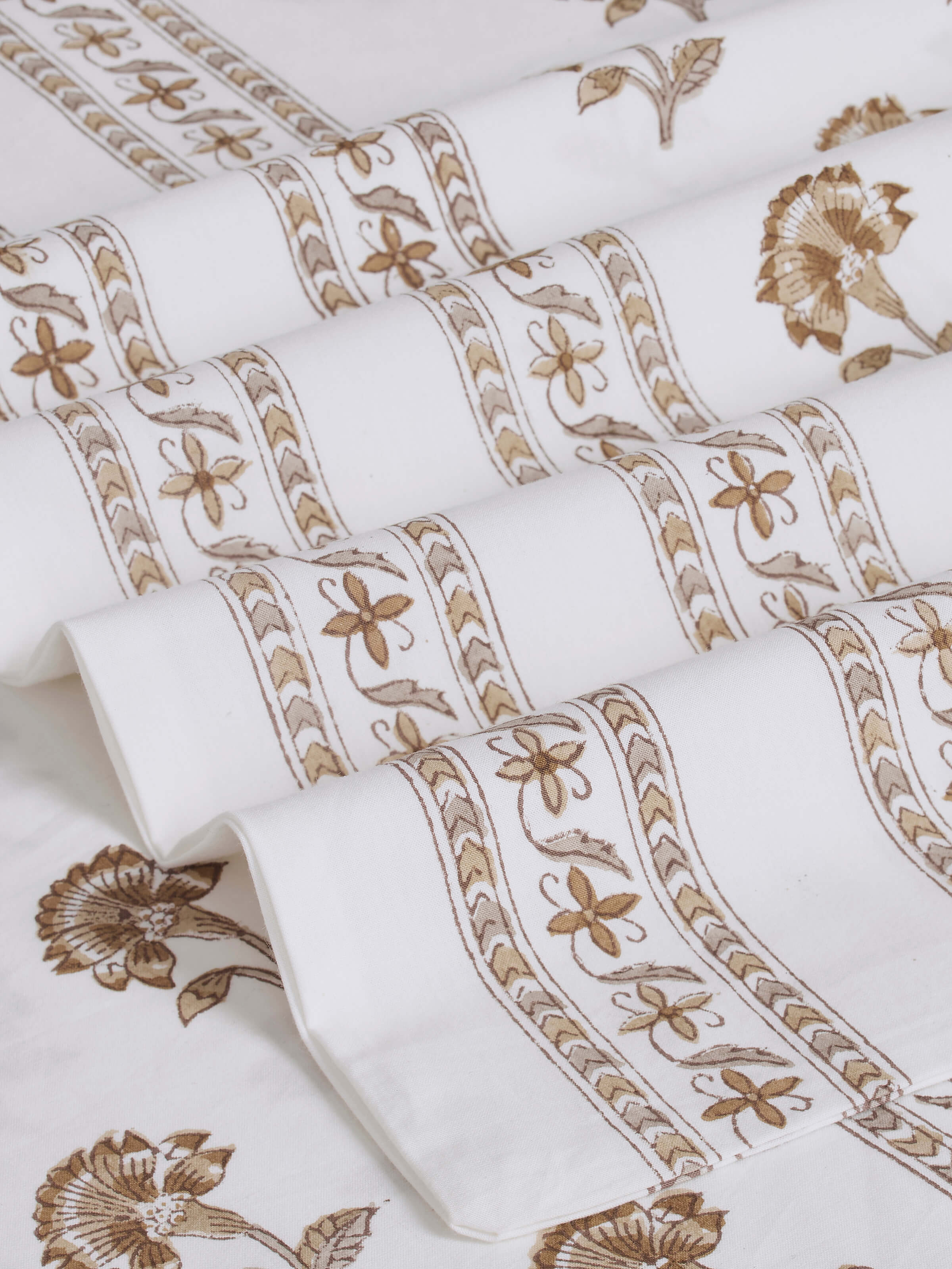 Detailed view of Aarunya beige buti cotton Sanganeri block printed queen bedsheet, emphasizing the print and fabric texture.