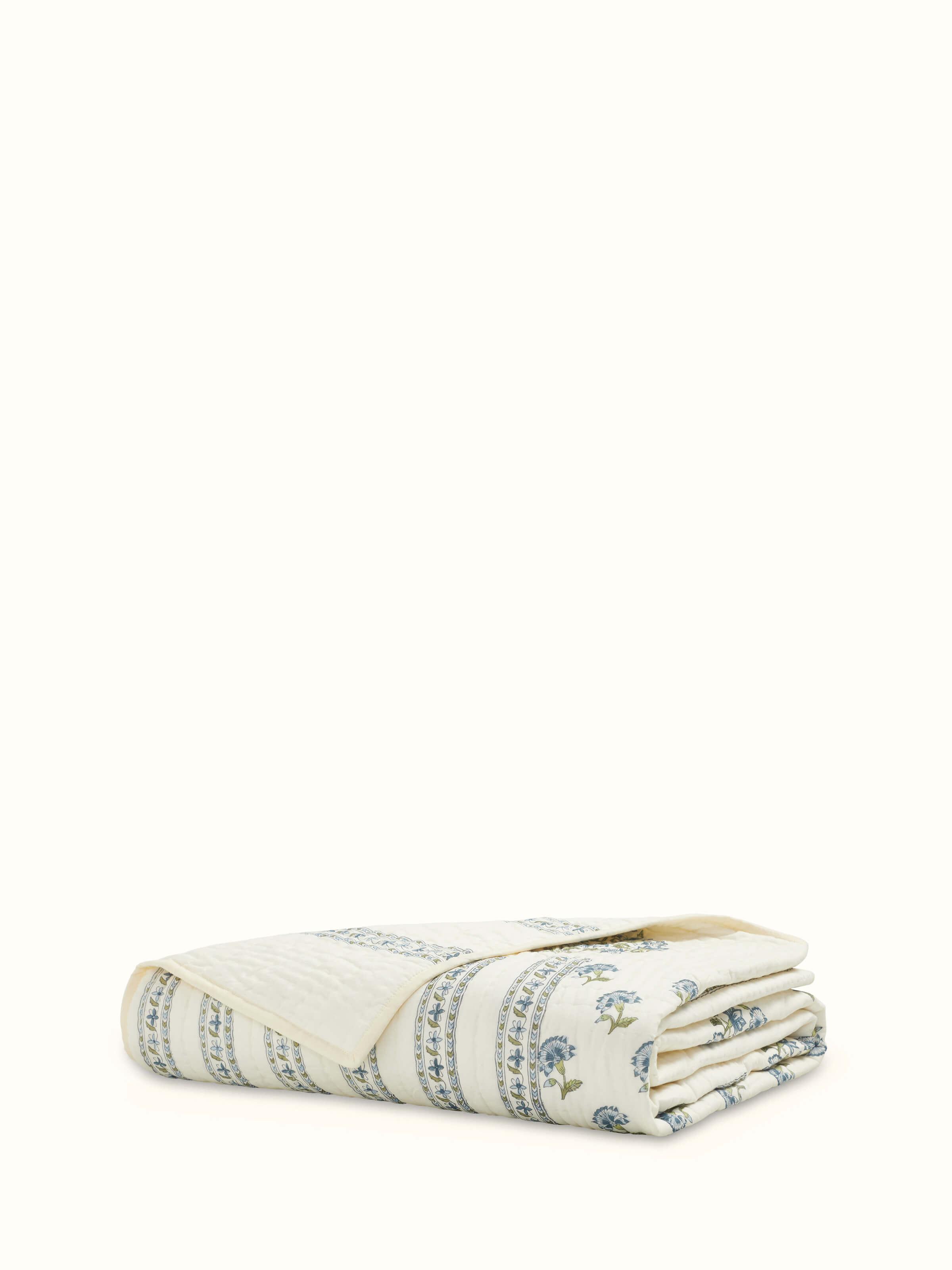 Full view of Aarunya blue floral cotton Sanganeri block printed single quilt showing the floral block print and color