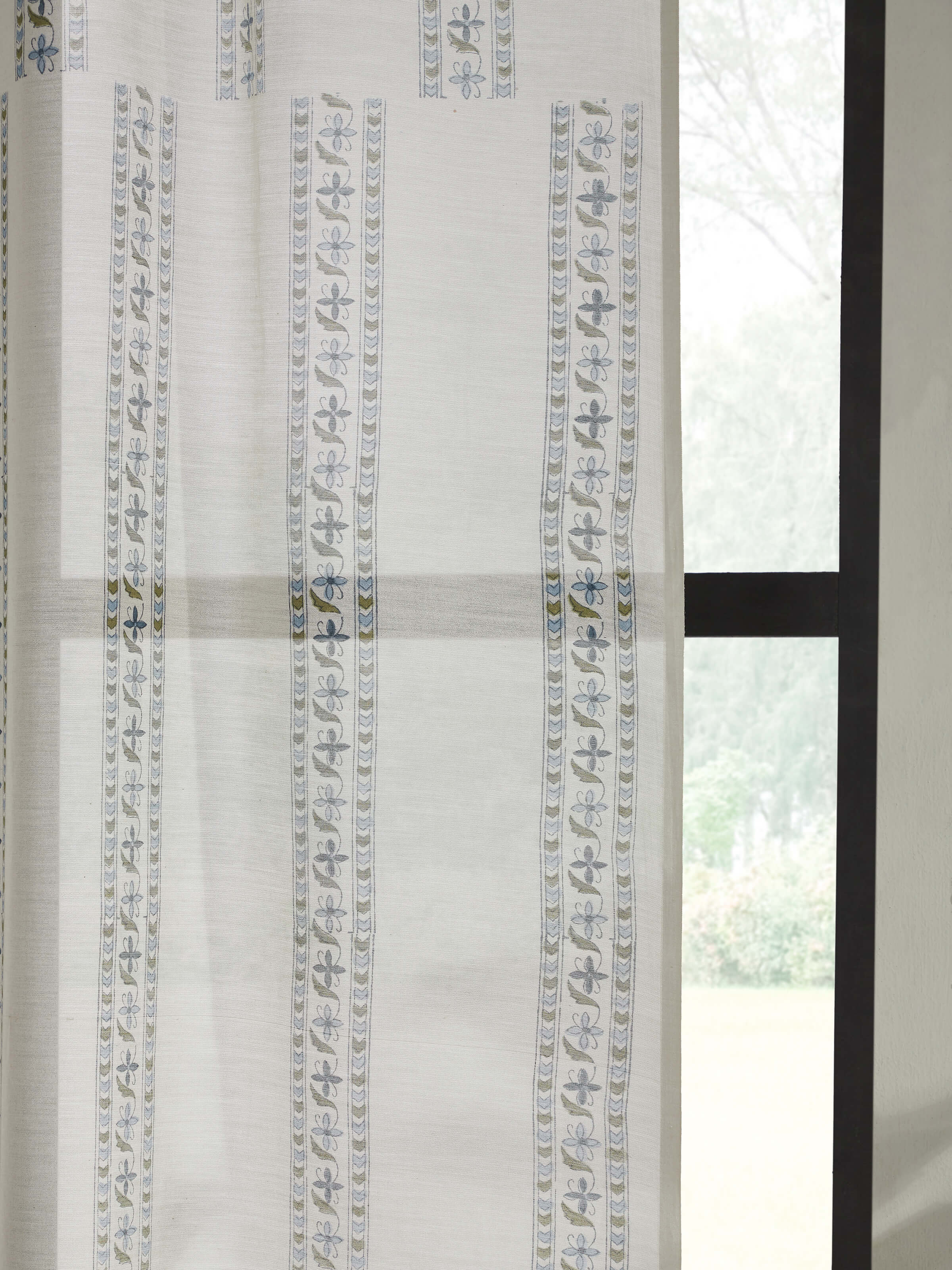 Artistic view of Aaarunya blue floral border sheer curtain in a room setting