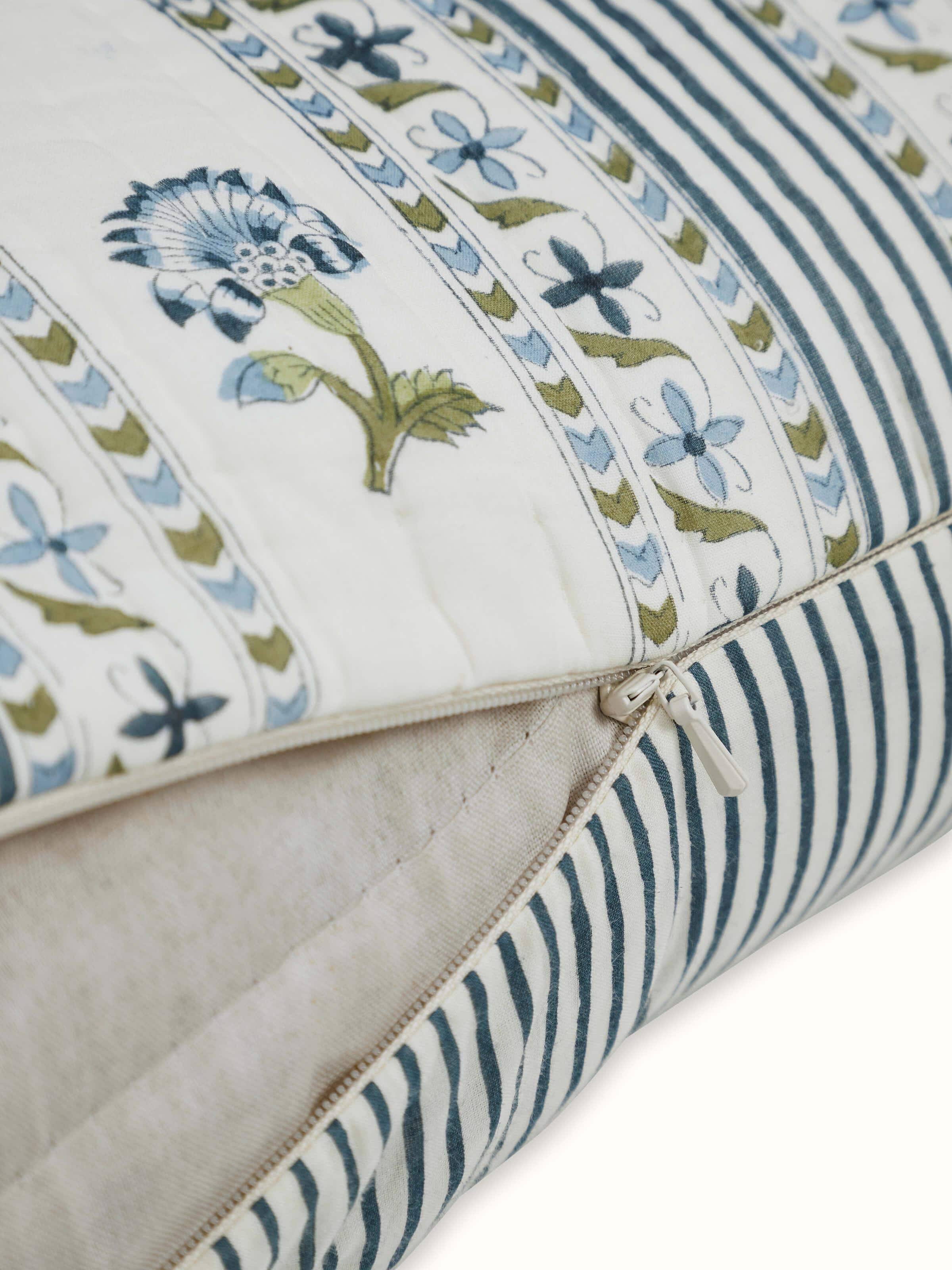 Angled view of Aaarunya blue floral cotton Sanganeri block printed cushion cover, revealing its design and cotton fabric