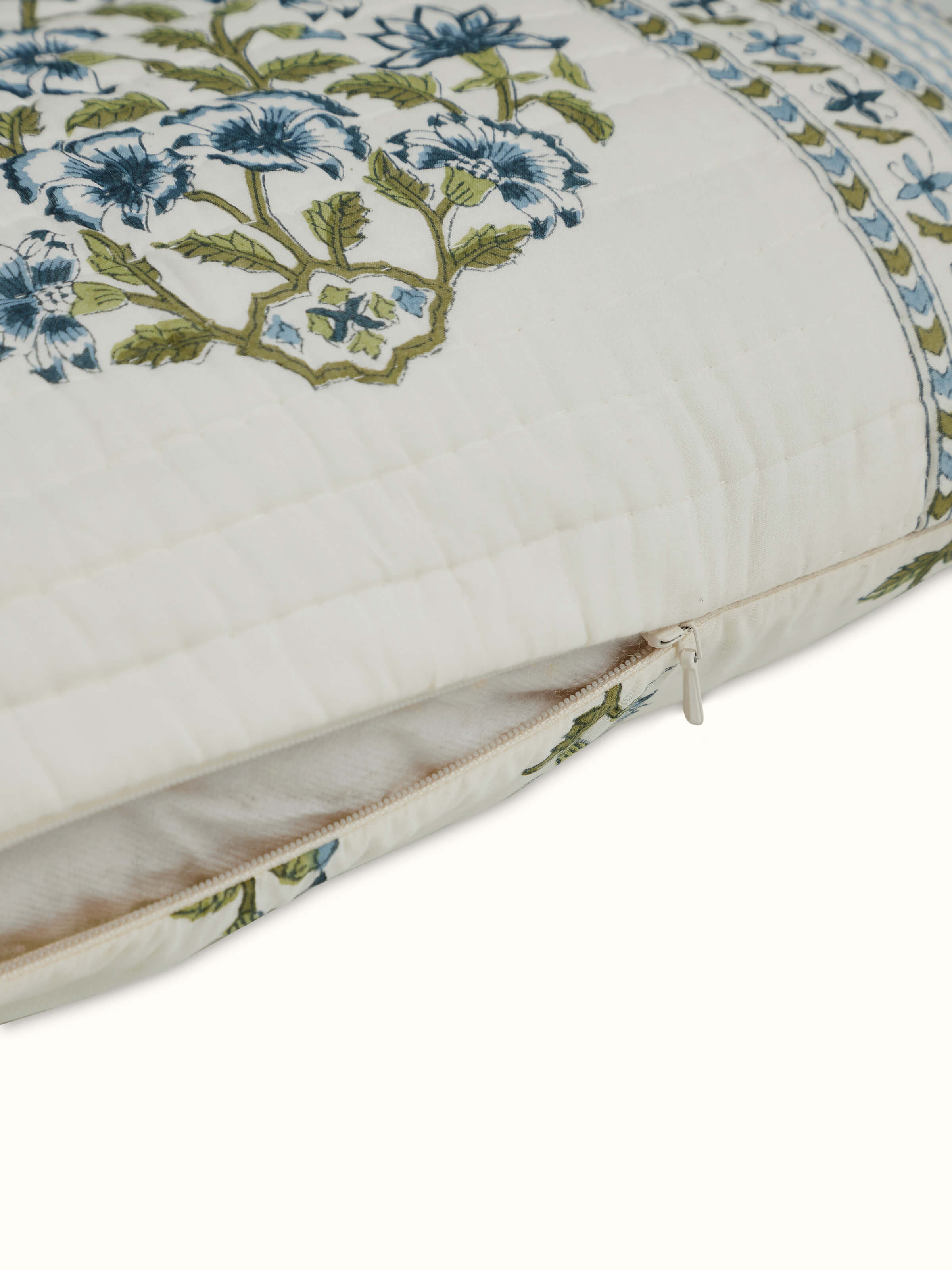 Aarunya blue buta cotton cushion cover displayed on a couch, illustrating its design and complementing interior decor