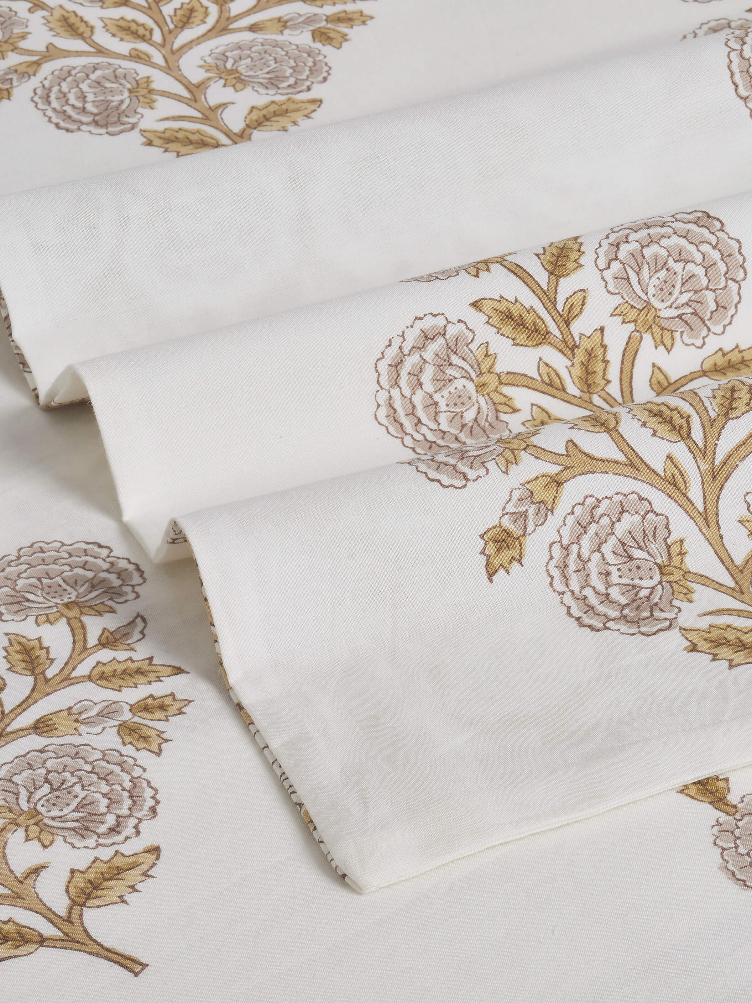 Angled view of a brown floral cotton Sanganeri block printed king bedsheet, highlighting the traditional block print design.
