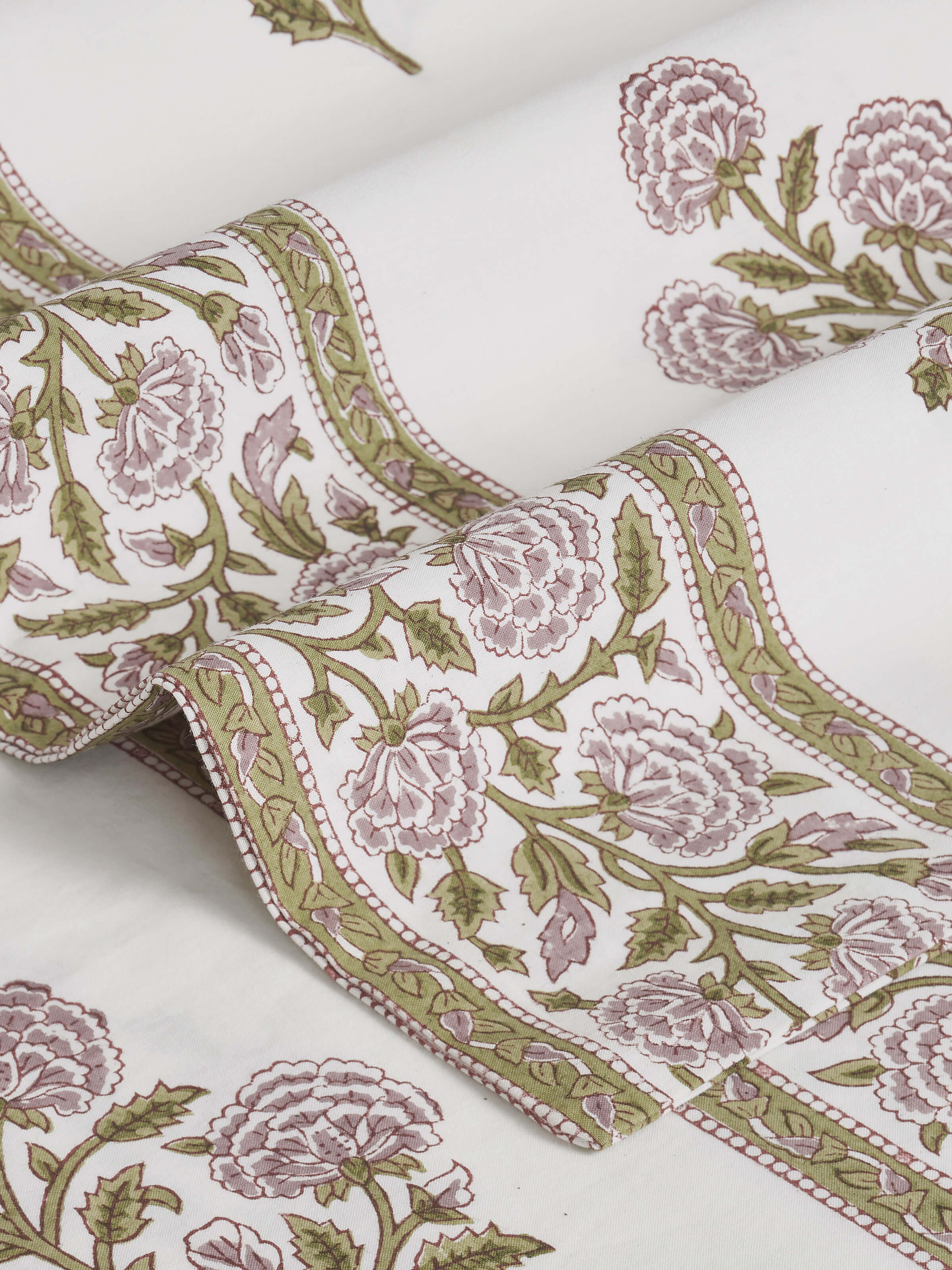 Folded queen bedsheet set featuring lavender buta Sanganeri block print, highlighting the fabric’s design and color