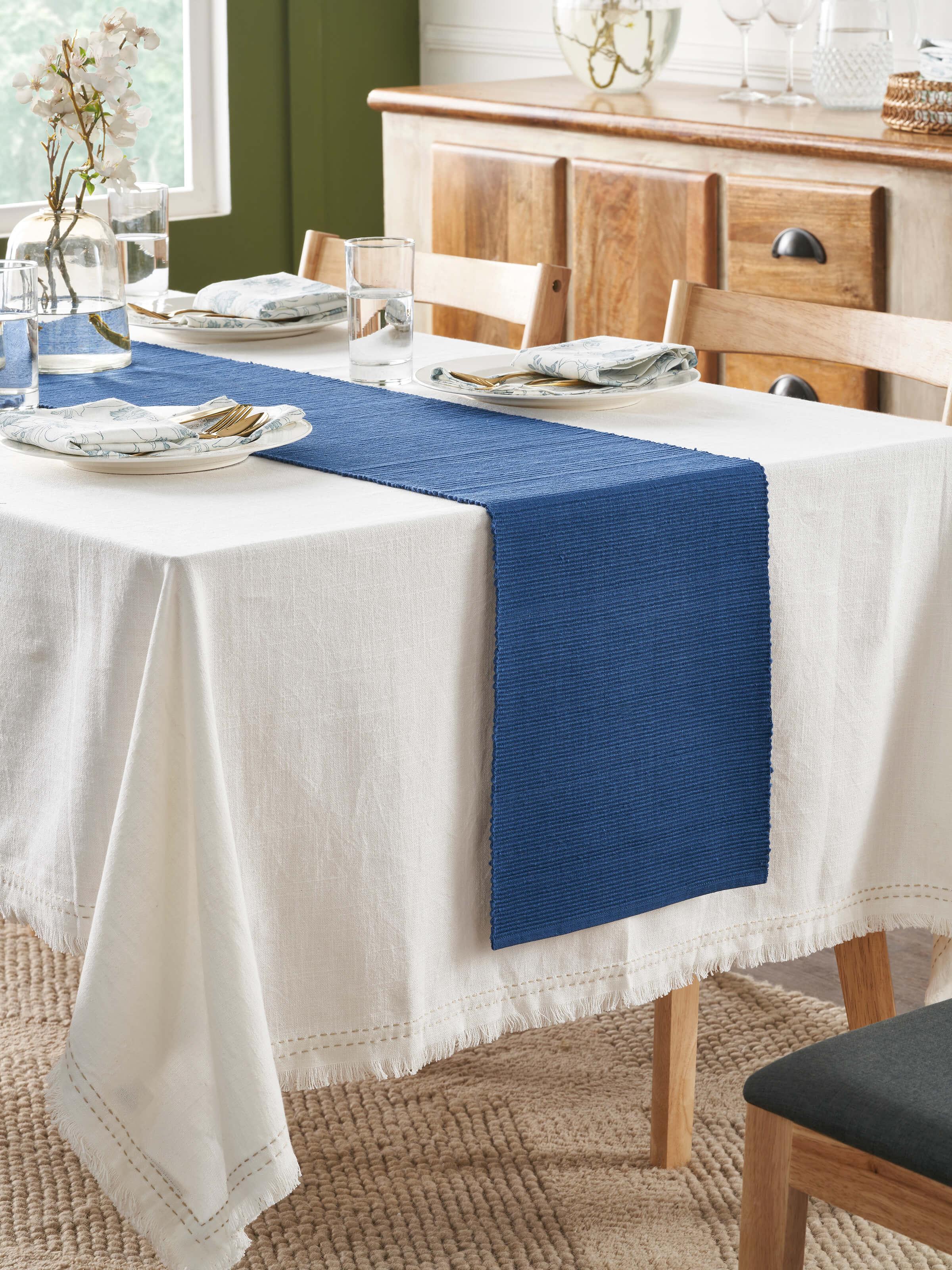 Dining scene featuring Vastav indigo table runner on wooden 6-seater table.