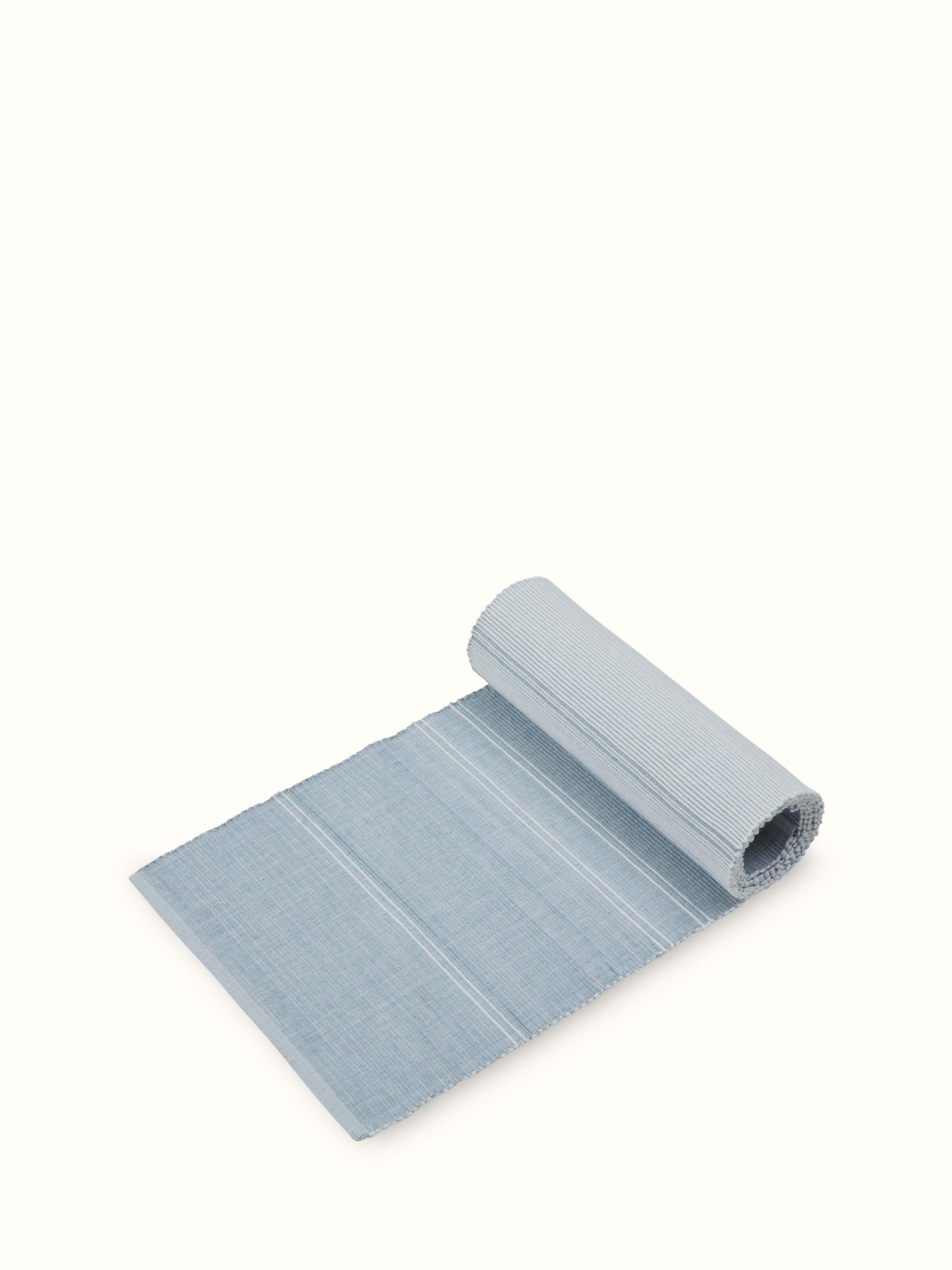 Angled view: Angled shot of handloom runner showing neat weaving and pastel stripe design.