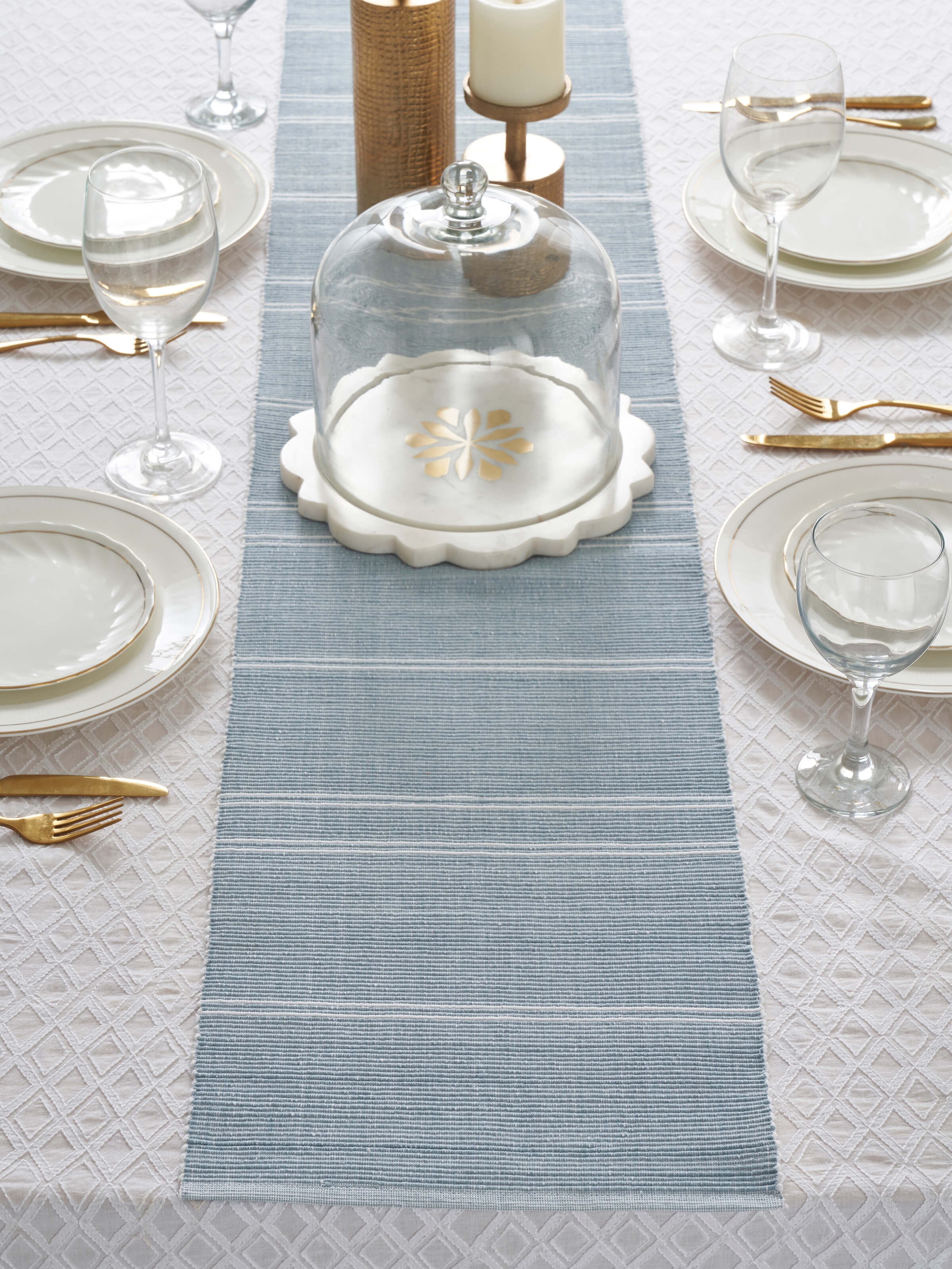 Lifestyle view of Vastav Light Blue Stripe Cotton Handloom Table Runner, showing the runner on a 4-seater table setting.