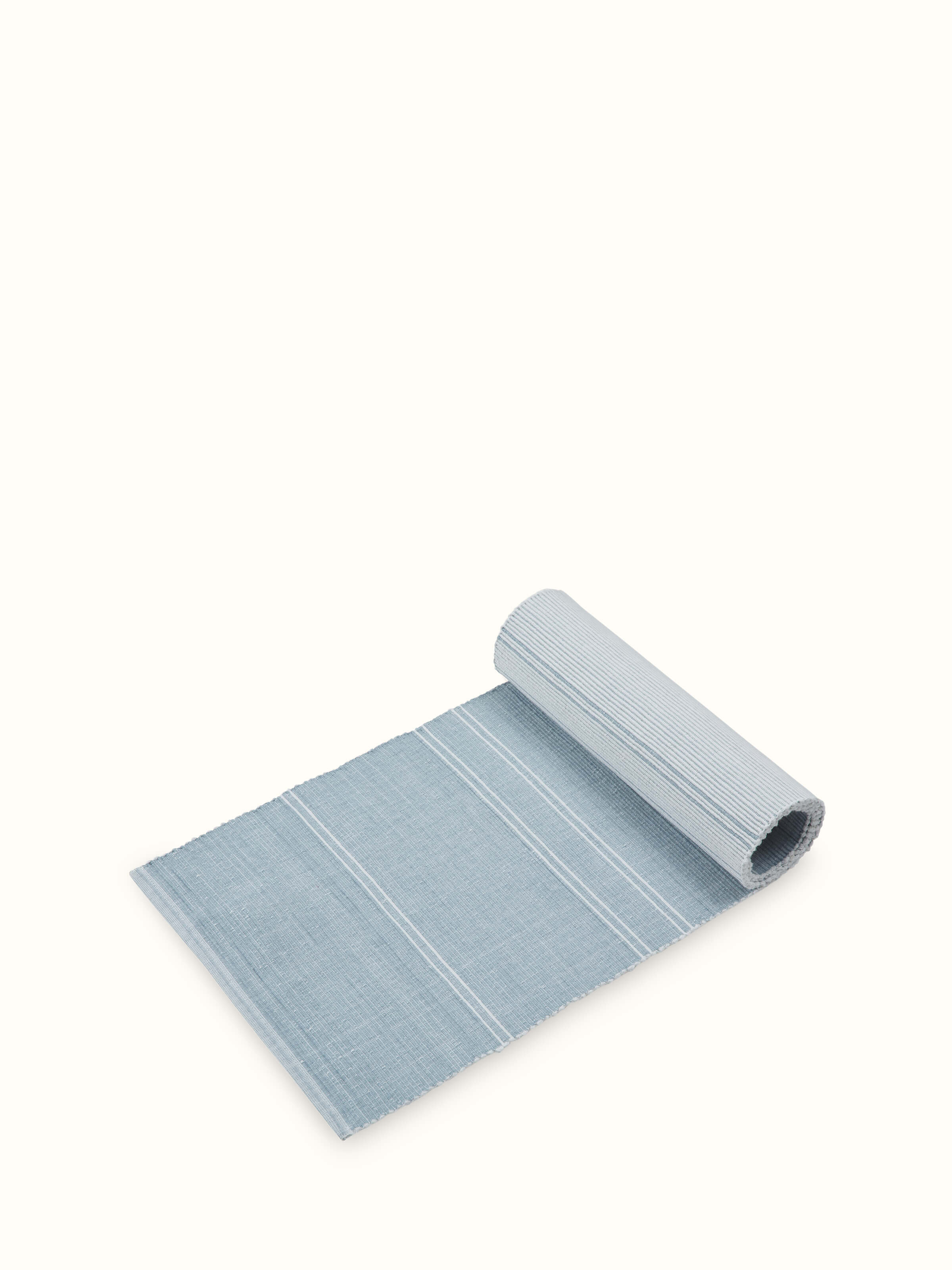 Angled view of Vastav Light Blue Stripe Cotton Handloom Table Runner, highlighting the soft cotton texture and handwoven stripes.