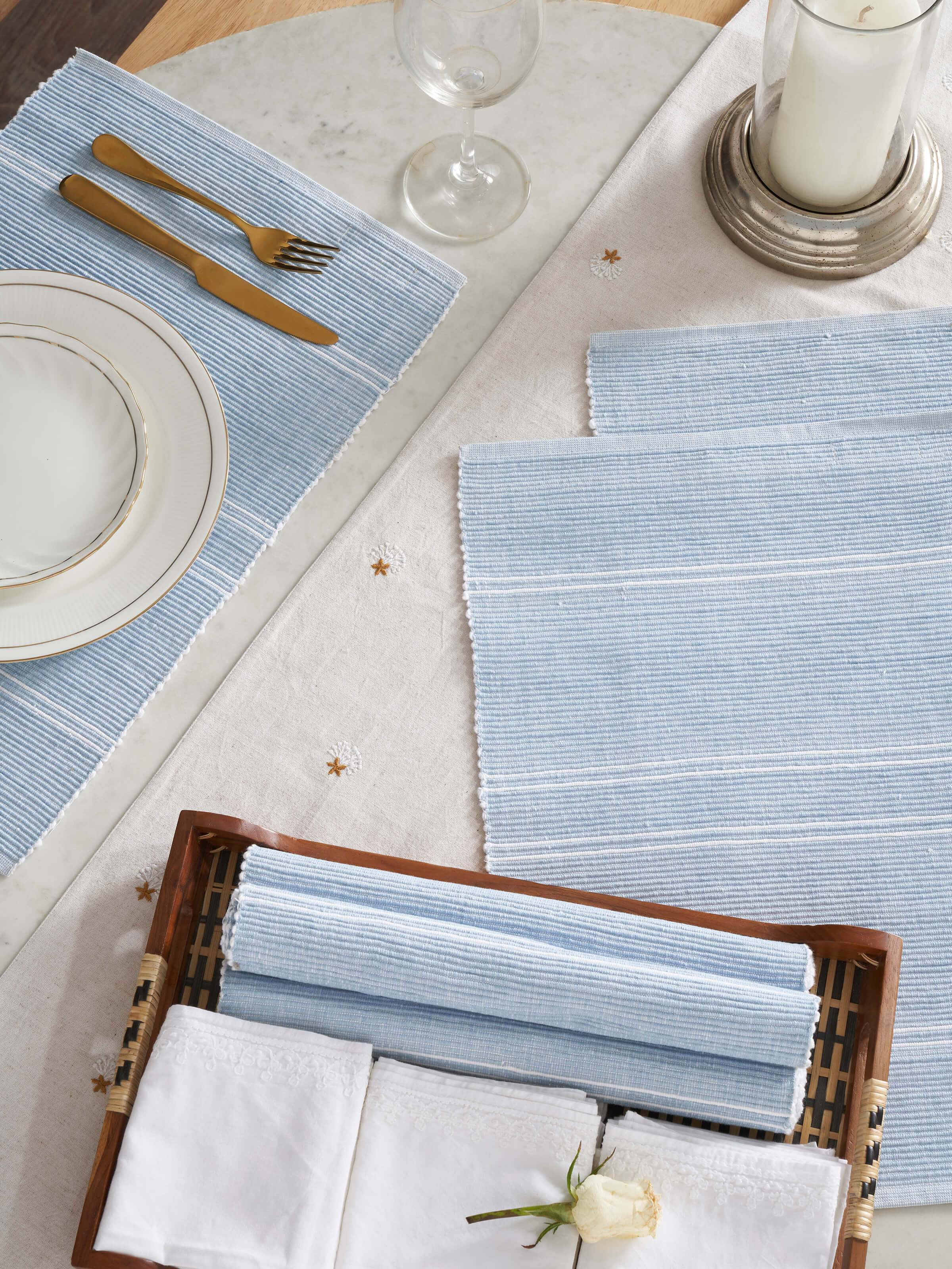 Lifestyle view of Arth Light Blue Handloom Table Mats styled with crockery on wooden table