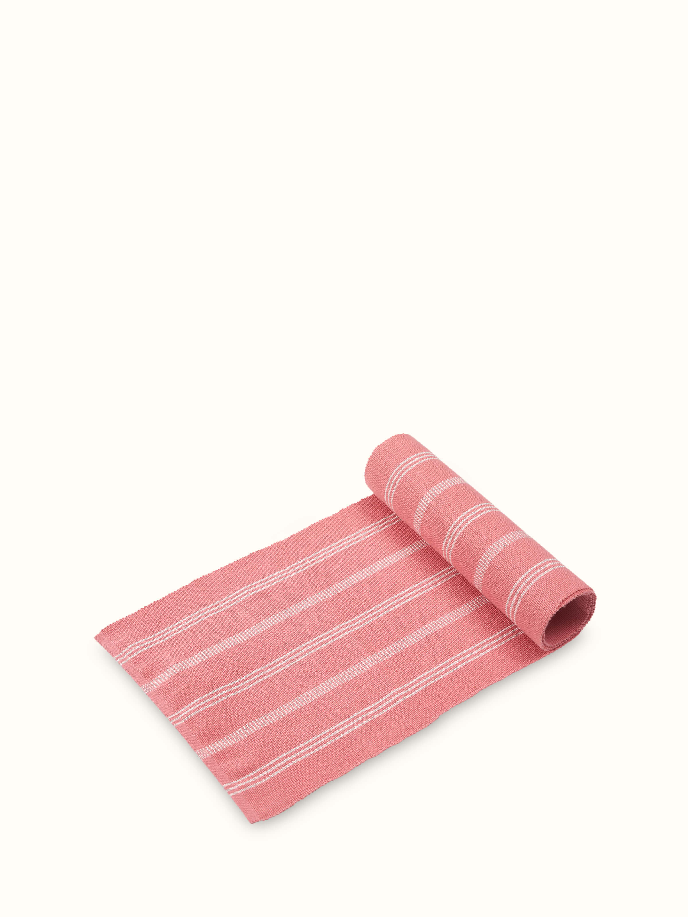 An angled close-up view of the Vastav Pink Stripe Cotton Handloom Table Runner for four-seaters, displaying the intricate pink stripe pattern and fine weaving details.