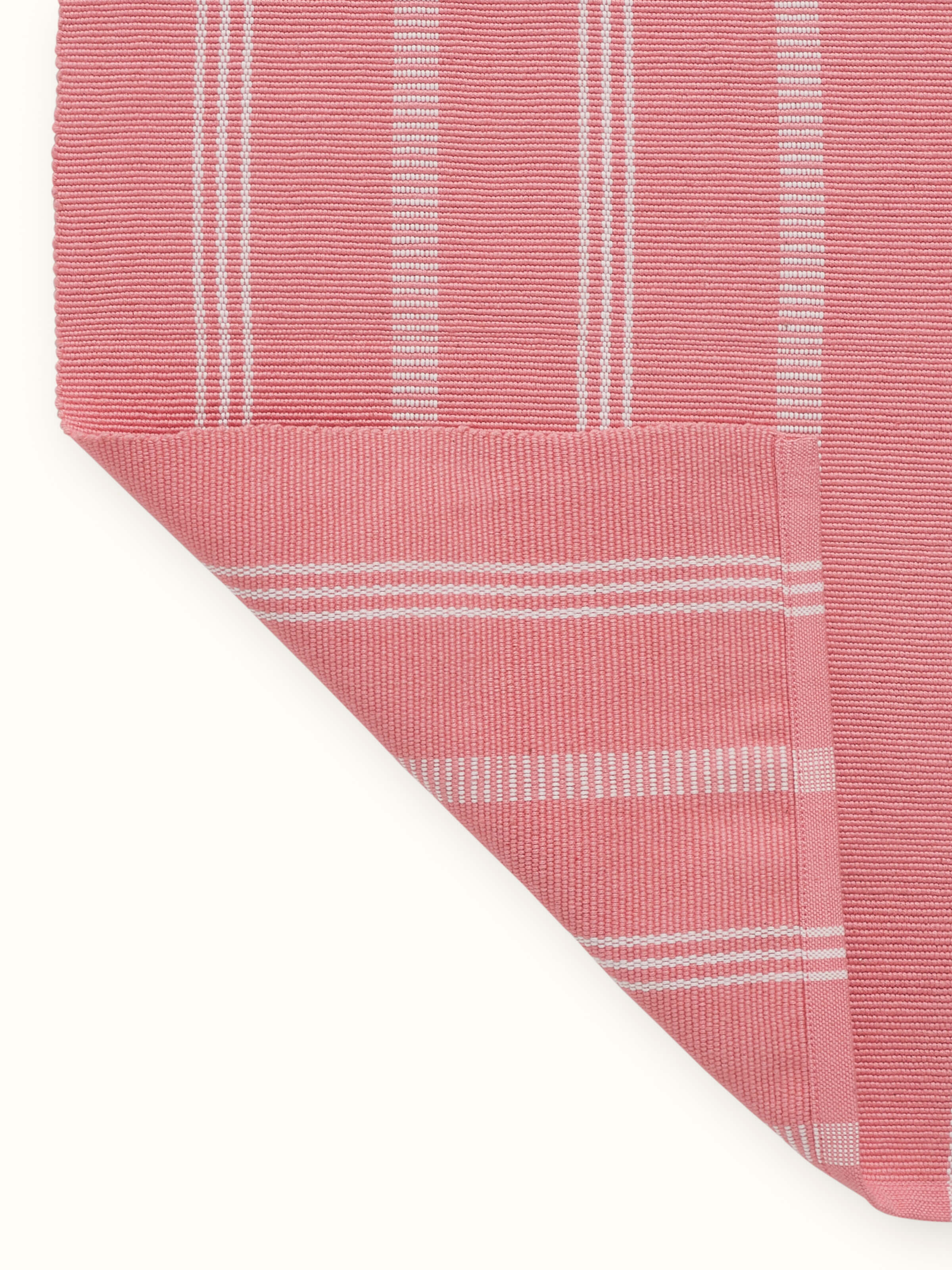 A back view of the Vastav Pink Stripe Cotton Handloom Table Runner, showing the reverse side of the handloom weave and structure, made with eco-friendly cotton by Swadesh.