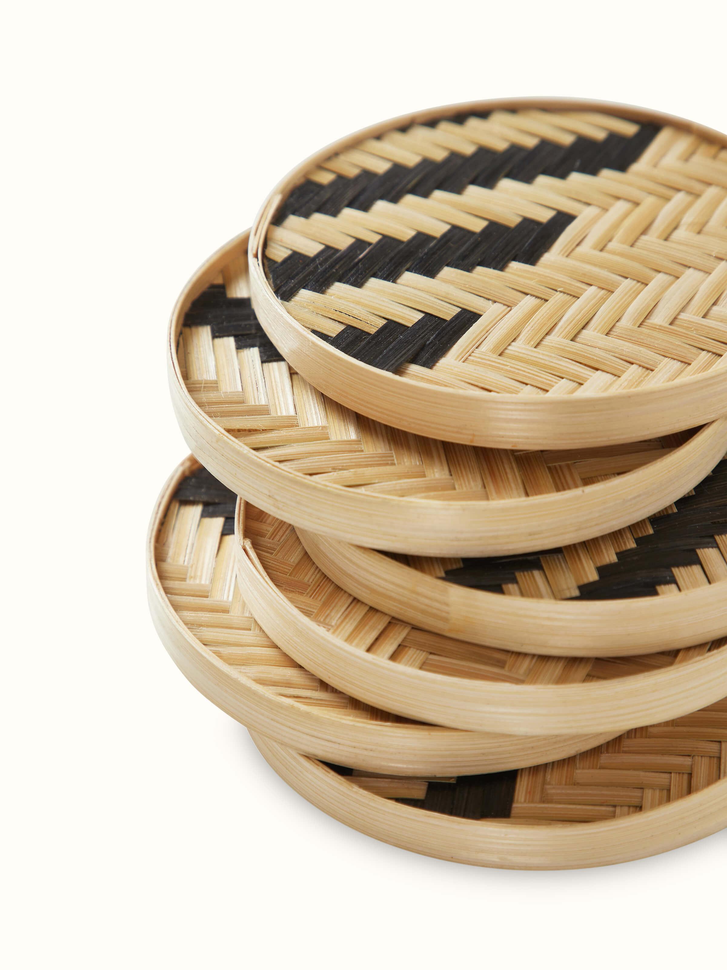 Angled view of Naveena Grey Checks Round Natural Fibre Coasters, displaying the coasters' design and material.