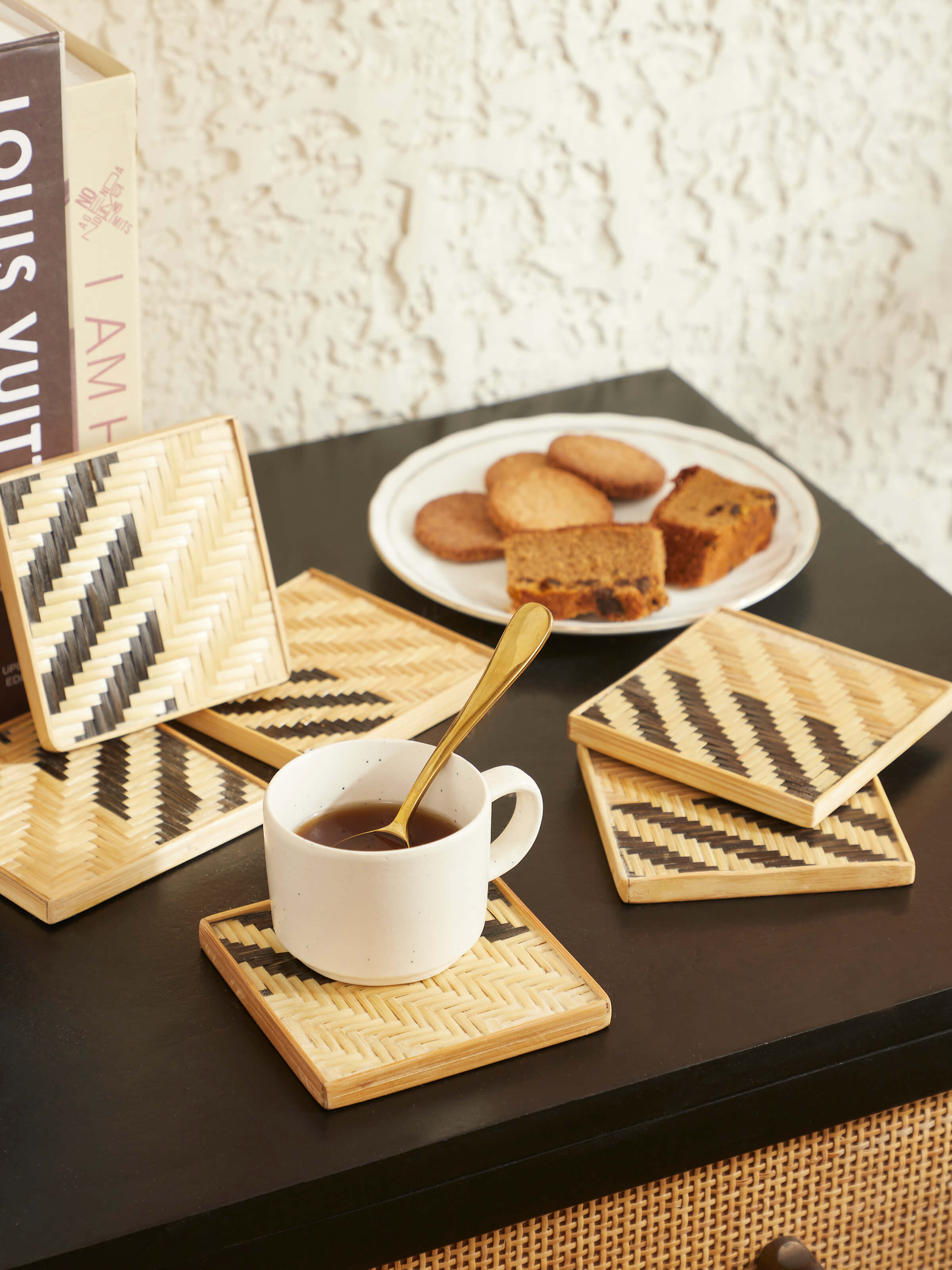 Close-up of Naveena grey geometric square natural fibre coasters (6 pcs) showing the texture and geometric patterns of the coasters.