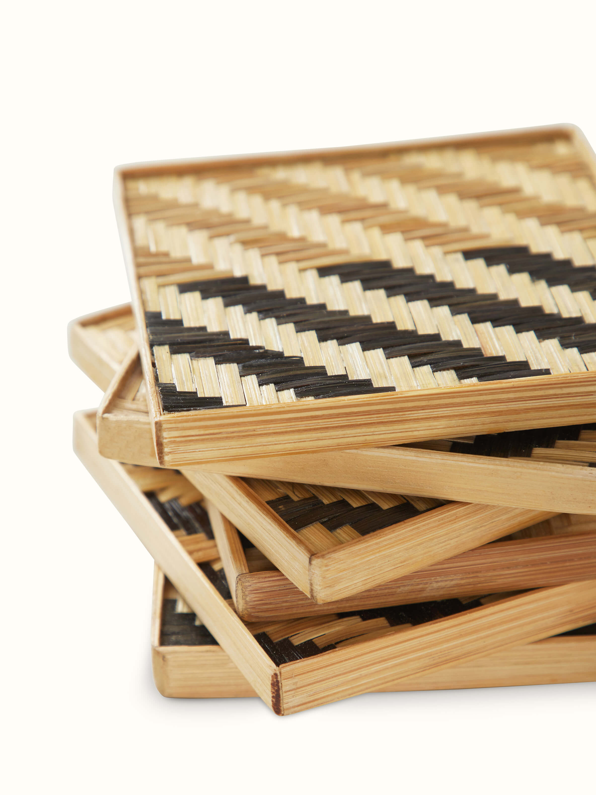 Perspective view of Naveena grey geometric square natural fibre coasters (6 pcs) showing the full set and their geometric design.