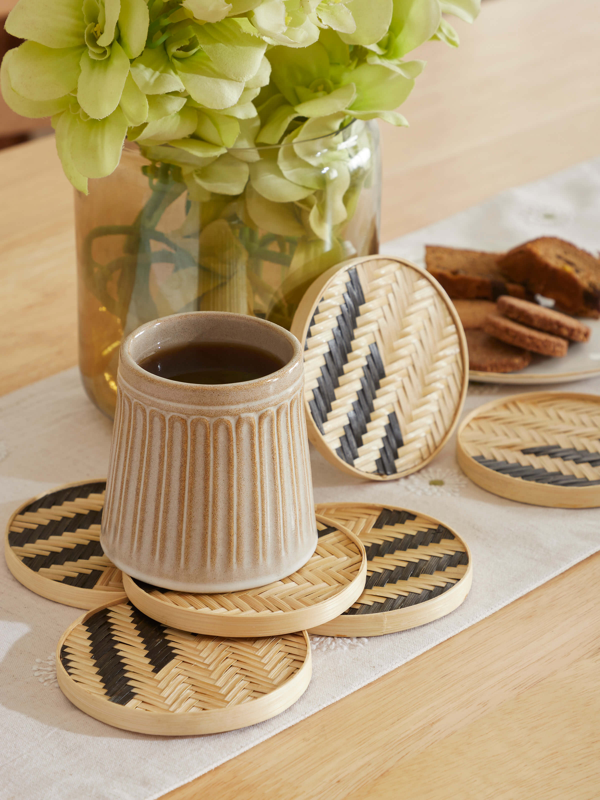Detailed view of Naveena brown geometric round natural fibre coasters (6 pcs) highlighting the intricate geometric pattern and natural fibre.
