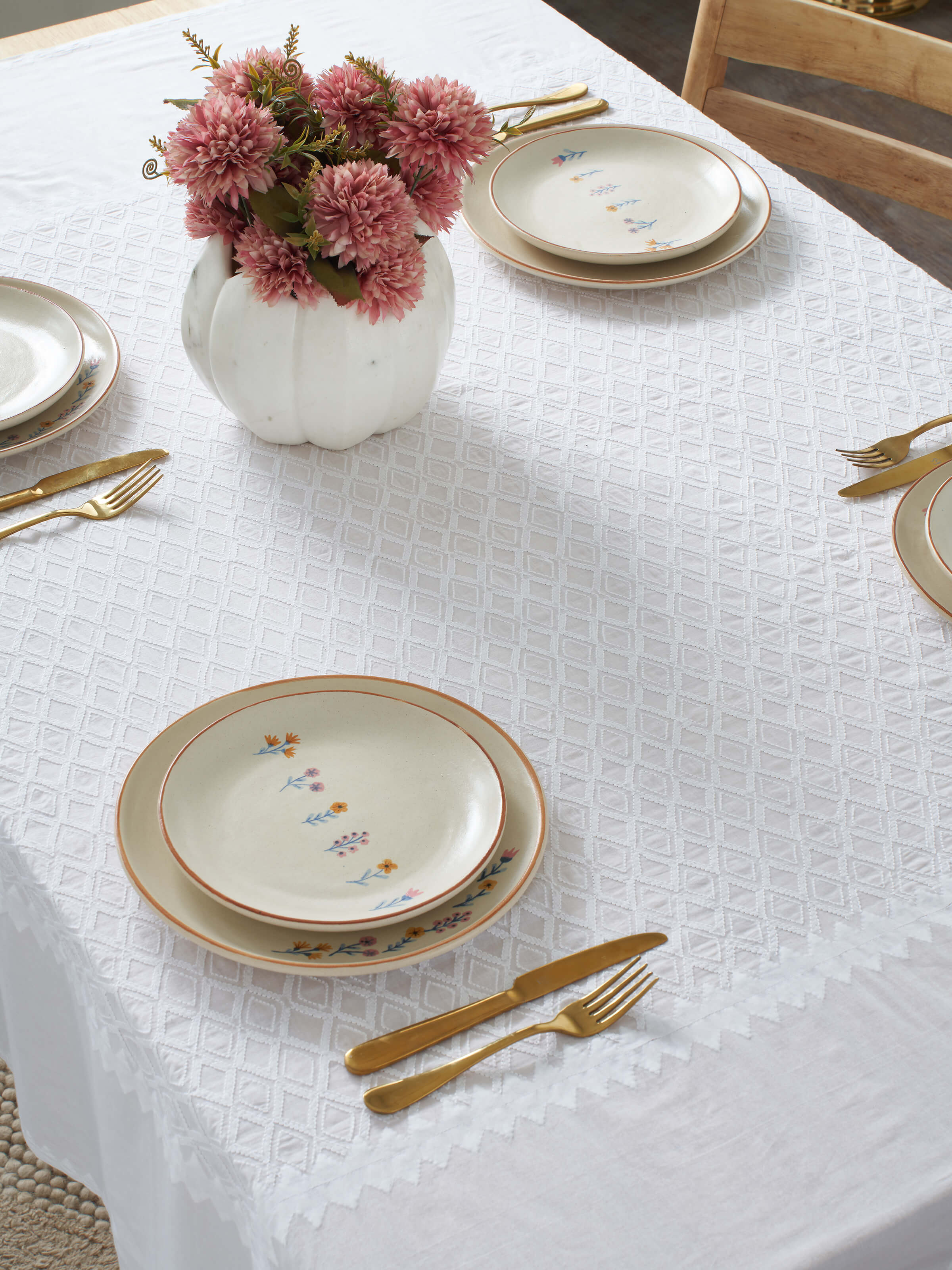 Close-up of Ananda white geometric cotton Chikankari table cover (4 seater) highlighting the detailed embroidery and pattern.