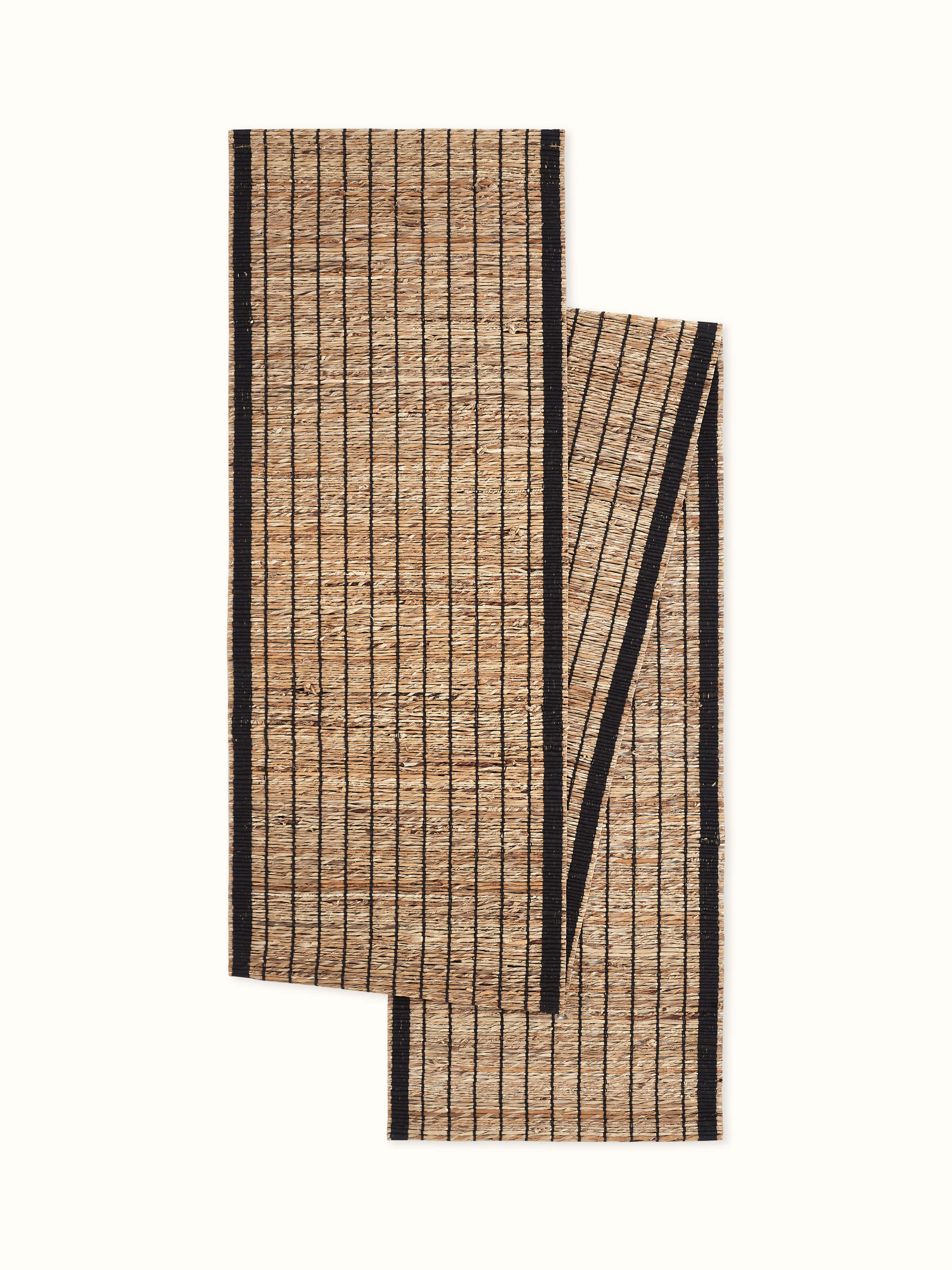 Front view of natural fibre banana table runner with black stripes and handwoven texture.