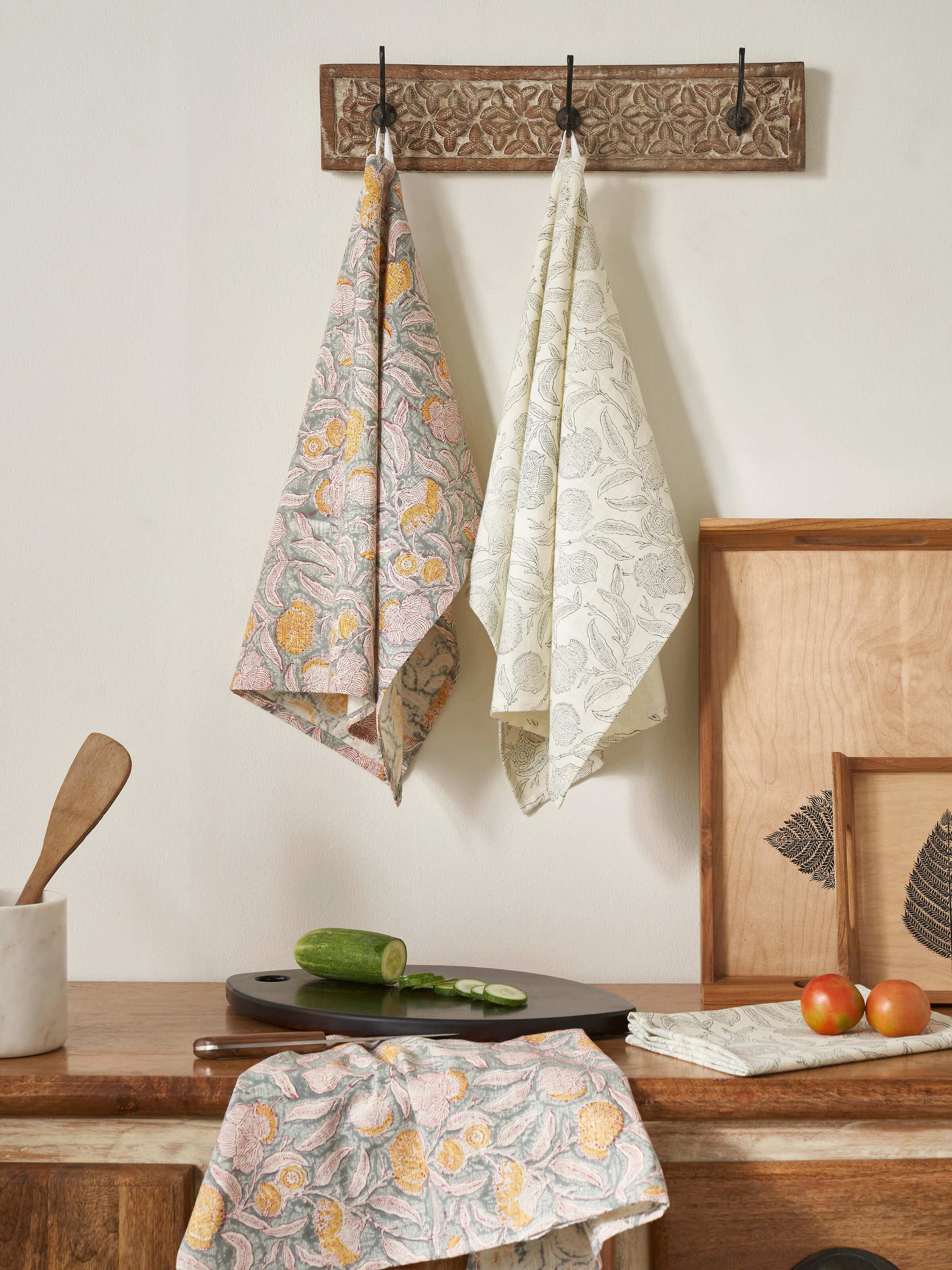 Close-up of Samaha grey floral dish towels showcasing the block print design and cotton material.