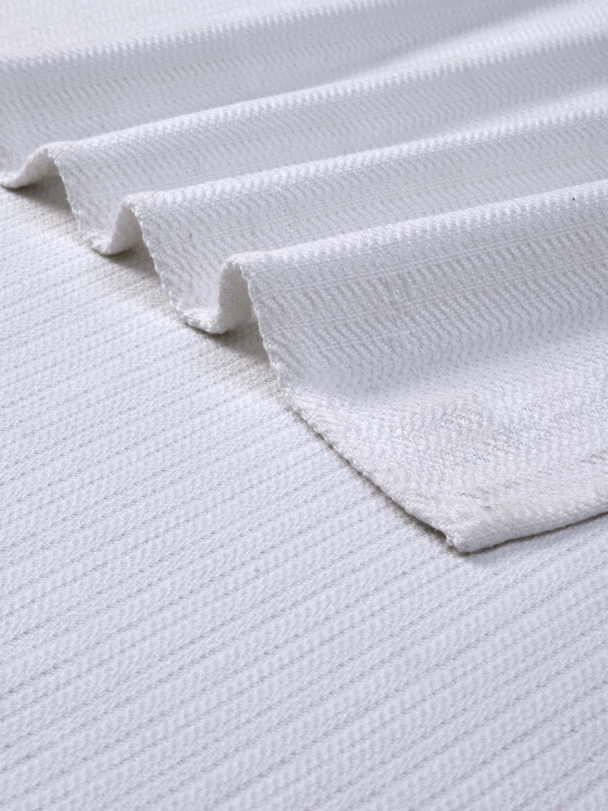 Vayana stripe white cotton striped bath towel (L), showing the towel folded to demonstrate its size and stripe pattern