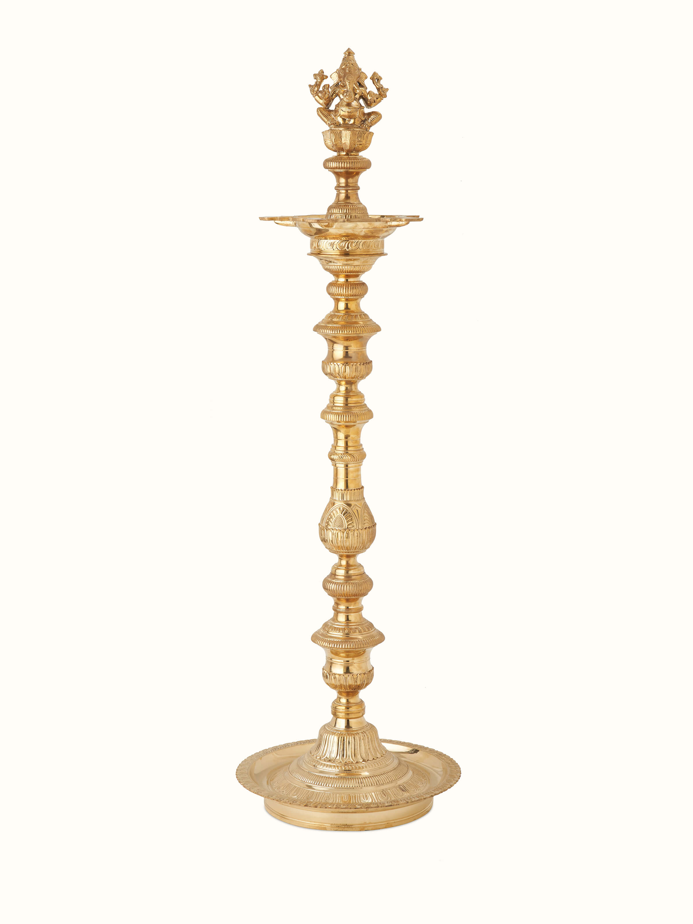 Front view of polished brass Vilakku stand diya with a gleaming finish