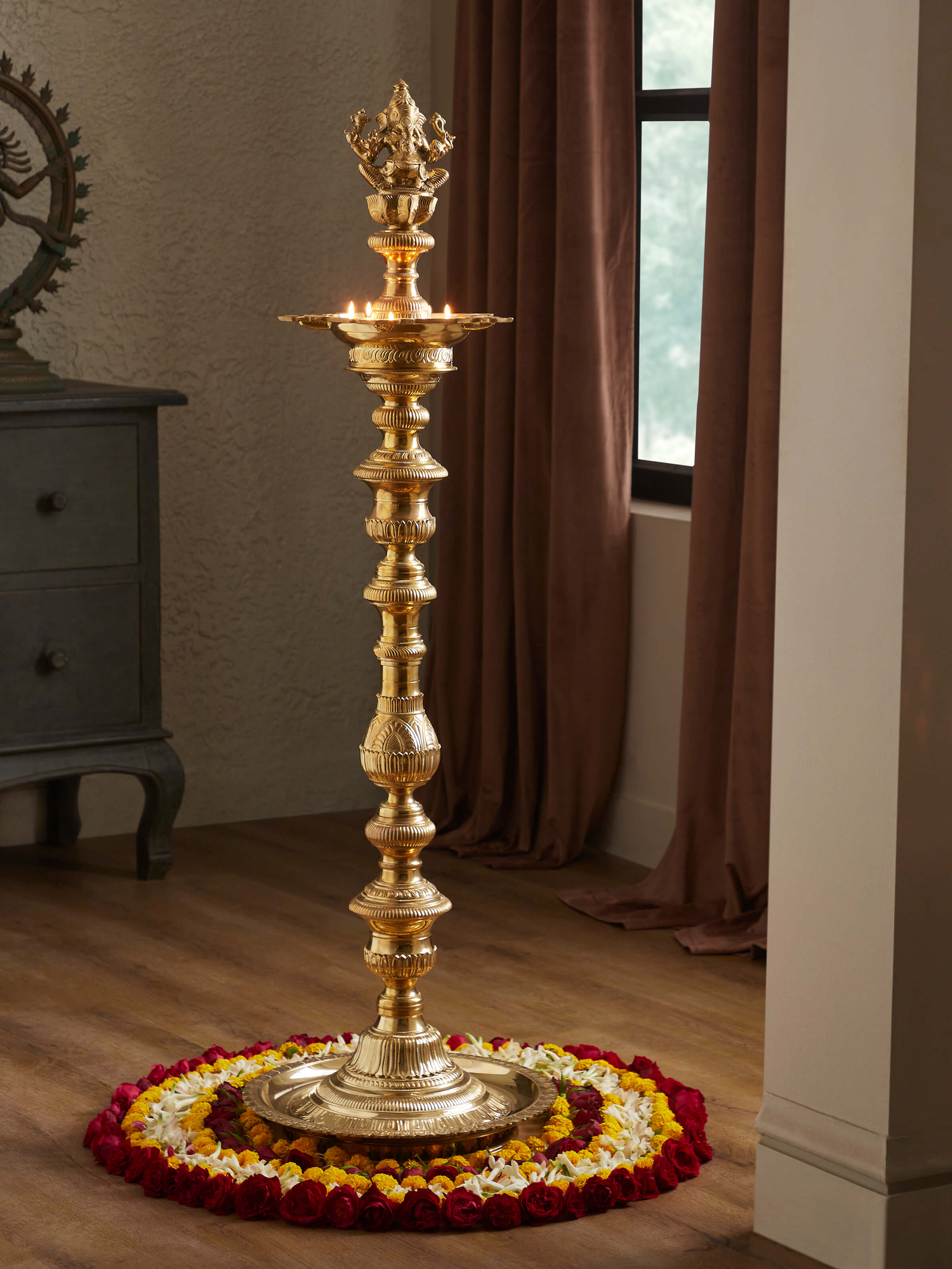 Side view of polished brass Vilakku stand diya showcasing smooth and reflective surface