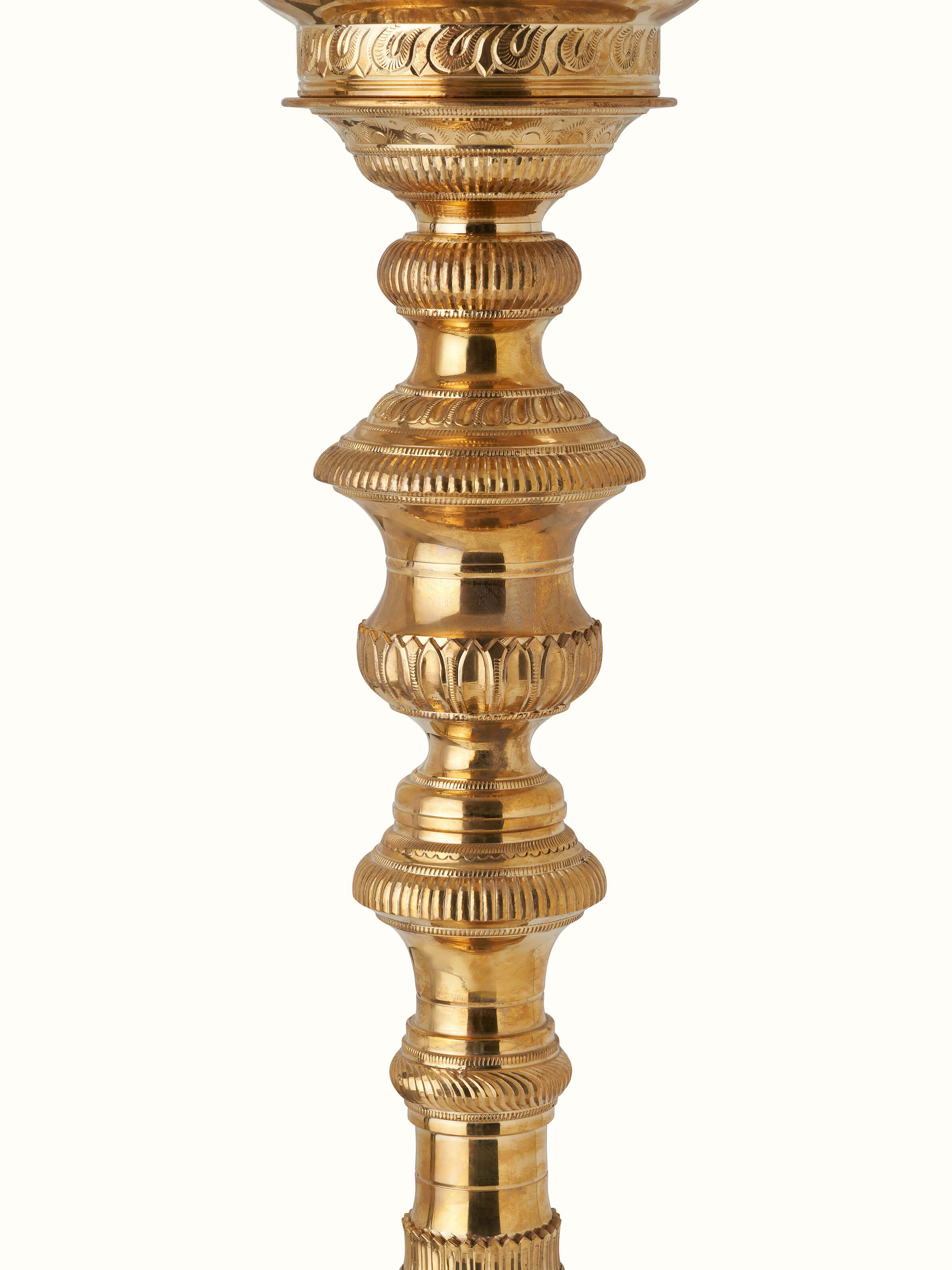 Detailed view of polished brass Vilakku stand diya highlighting fine craftsmanship