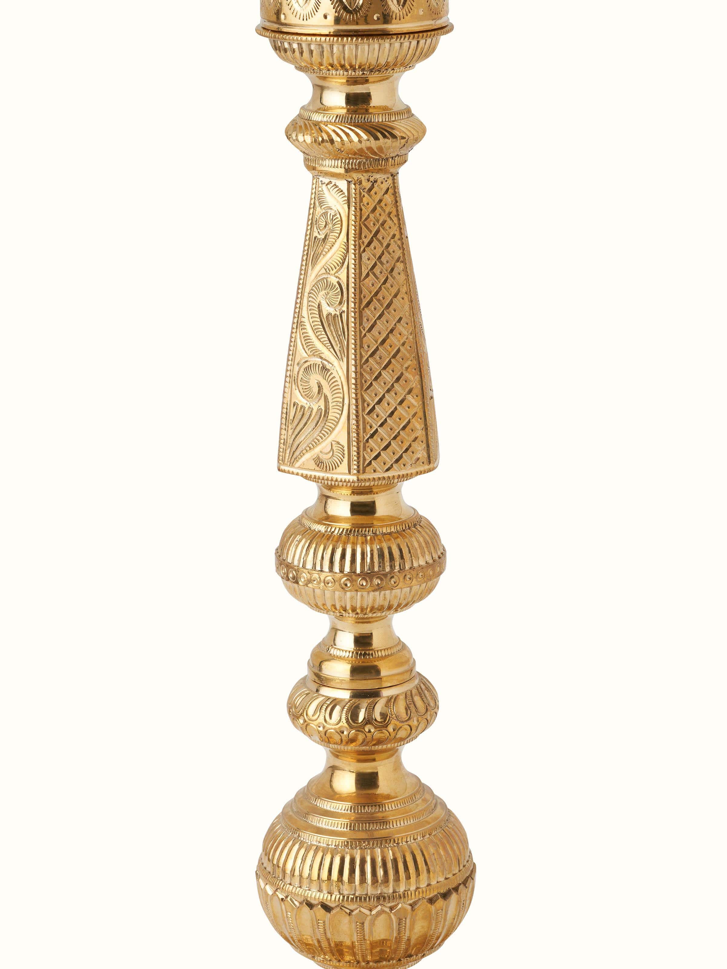 Angled view of Polished brass vilakku stand diya highlighting the ornate design and polished finish