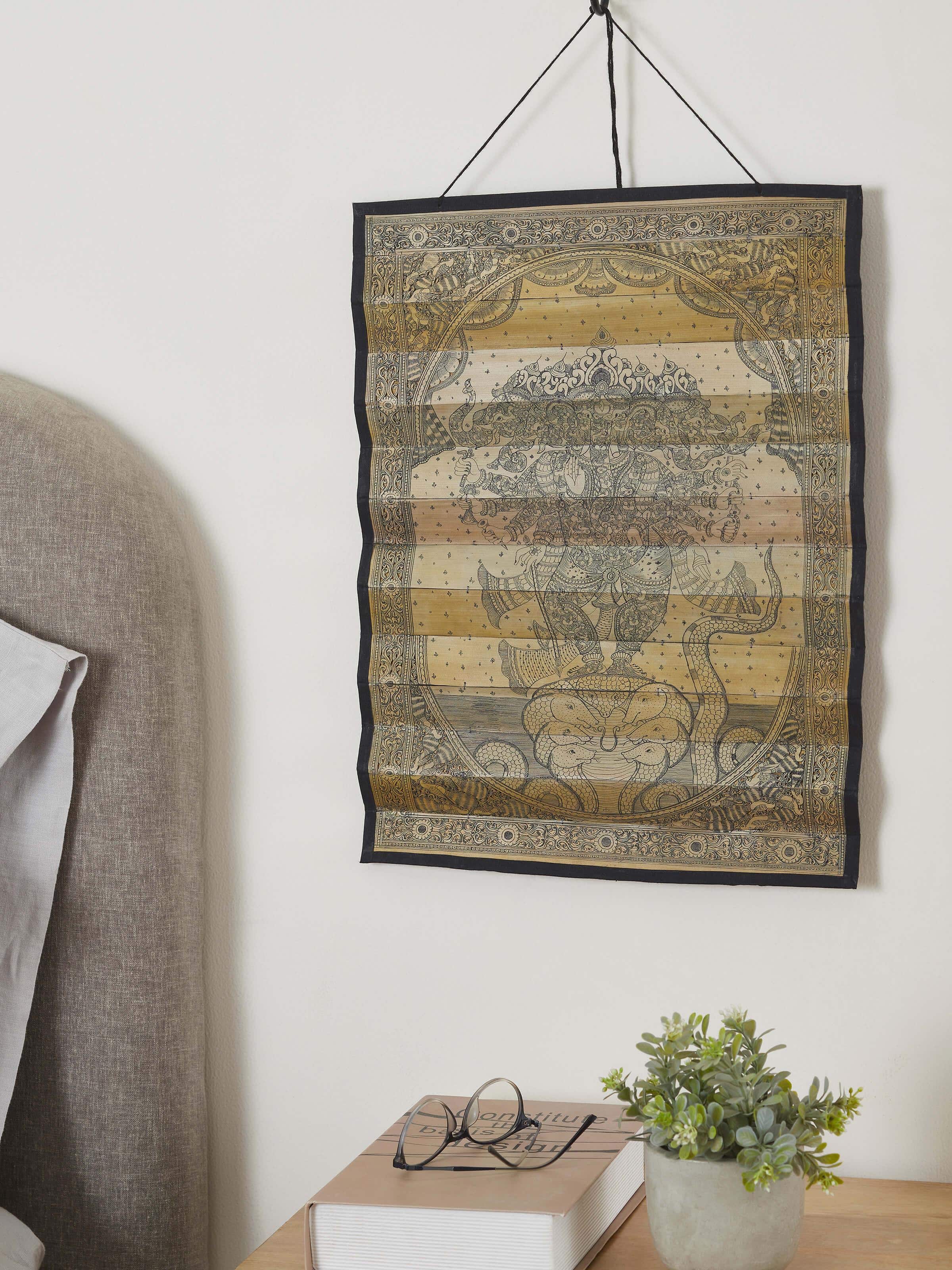 Side view of Palm Leaf Engraved Vakratunda Ganesha Wall Art, showcasing detailed engravings and sacred design.