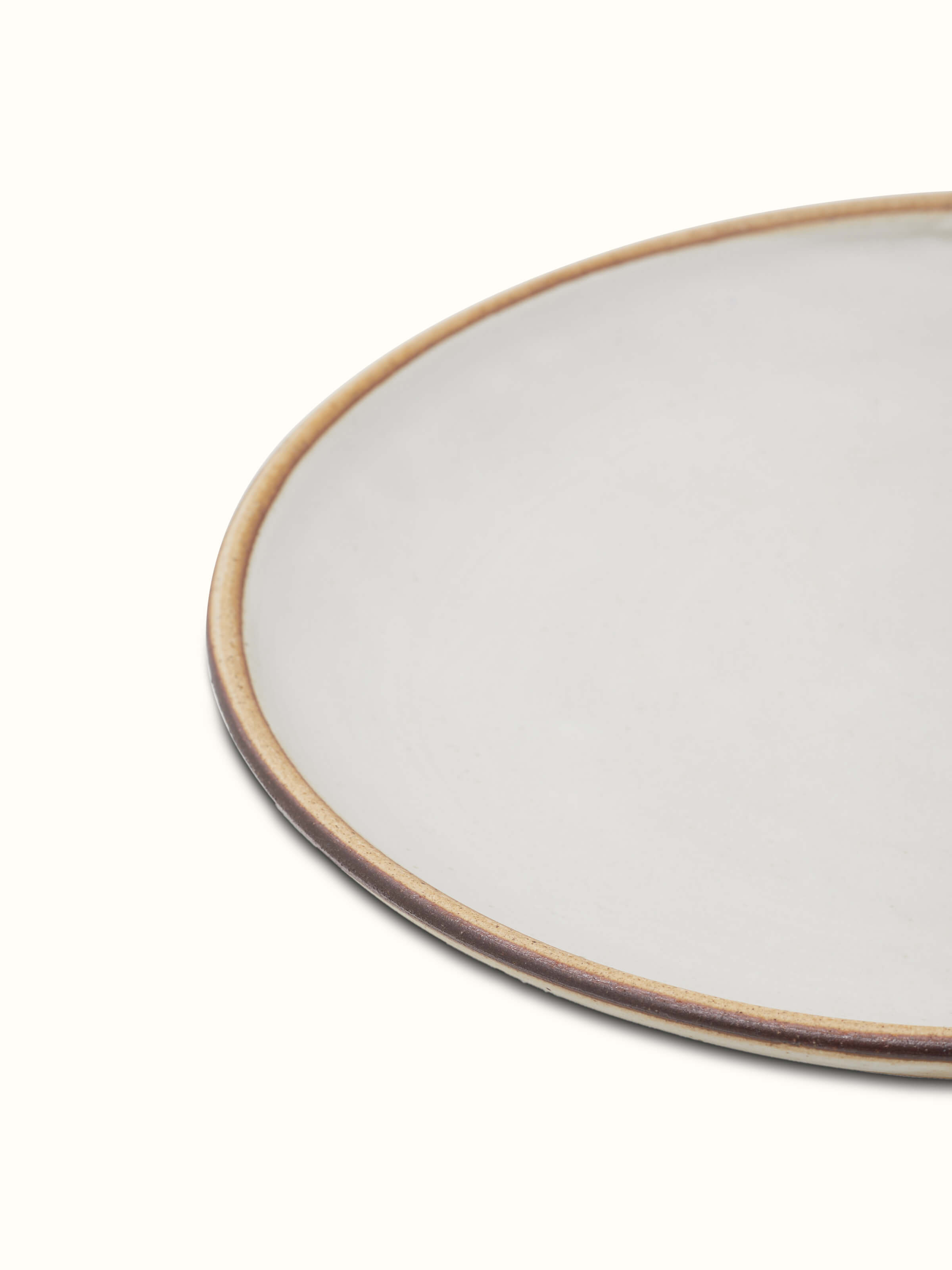 Close-up view of Studio pottery ceramic dinner plate white highlighting the smooth surface and elegant craftsmanship