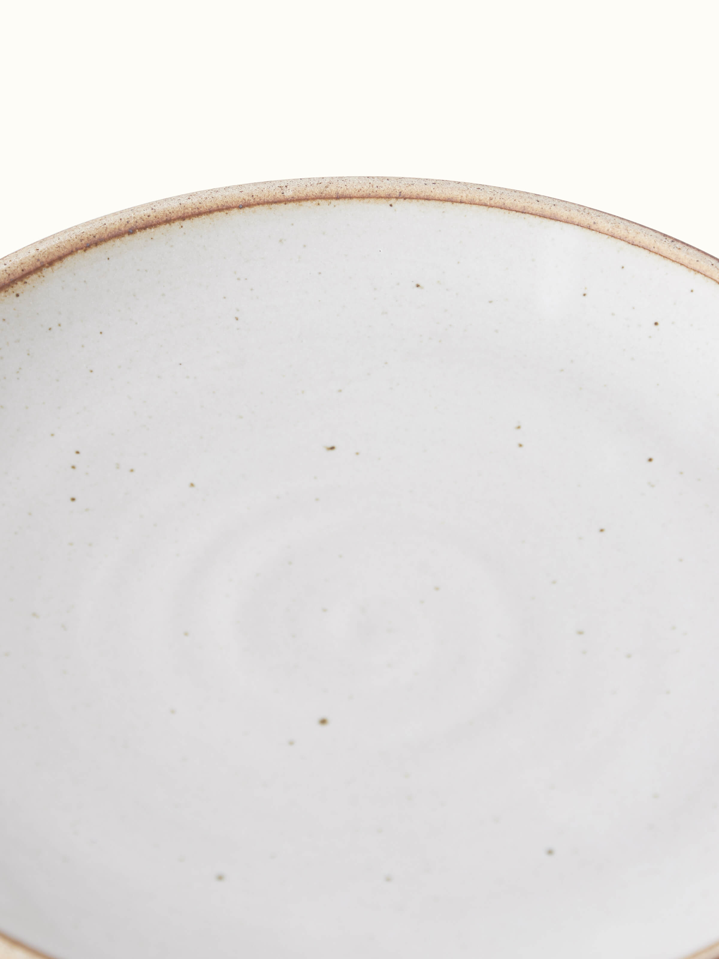 Studio pottery ceramic quarter plate with a focus on its artistic design and craftsmanship.