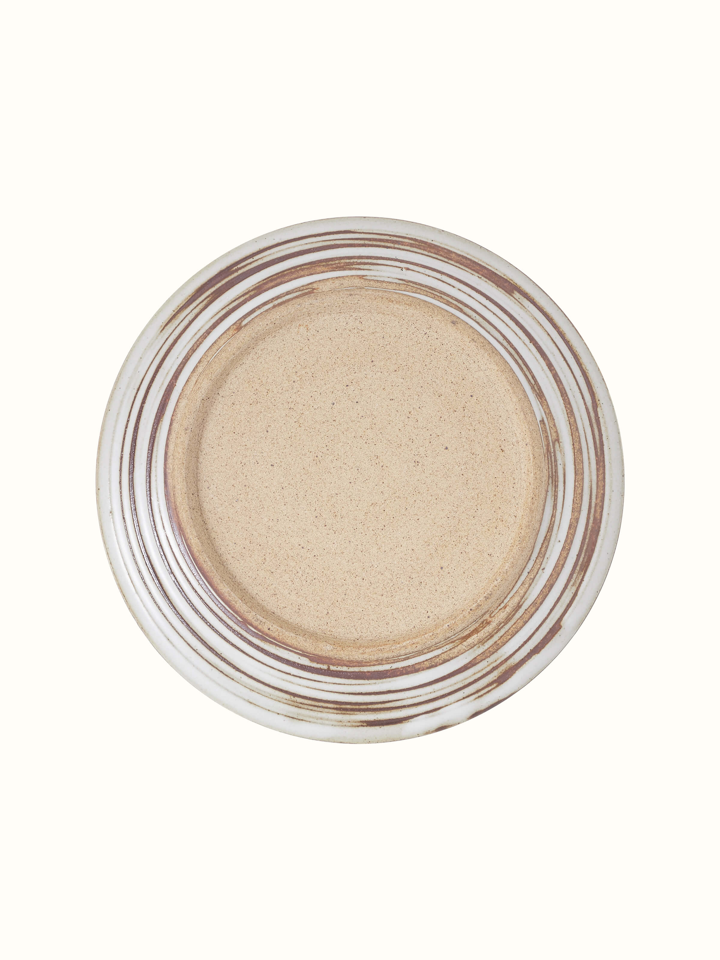 Studio pottery ceramic quarter plate with a focus on its unique texture and artistic glaze.