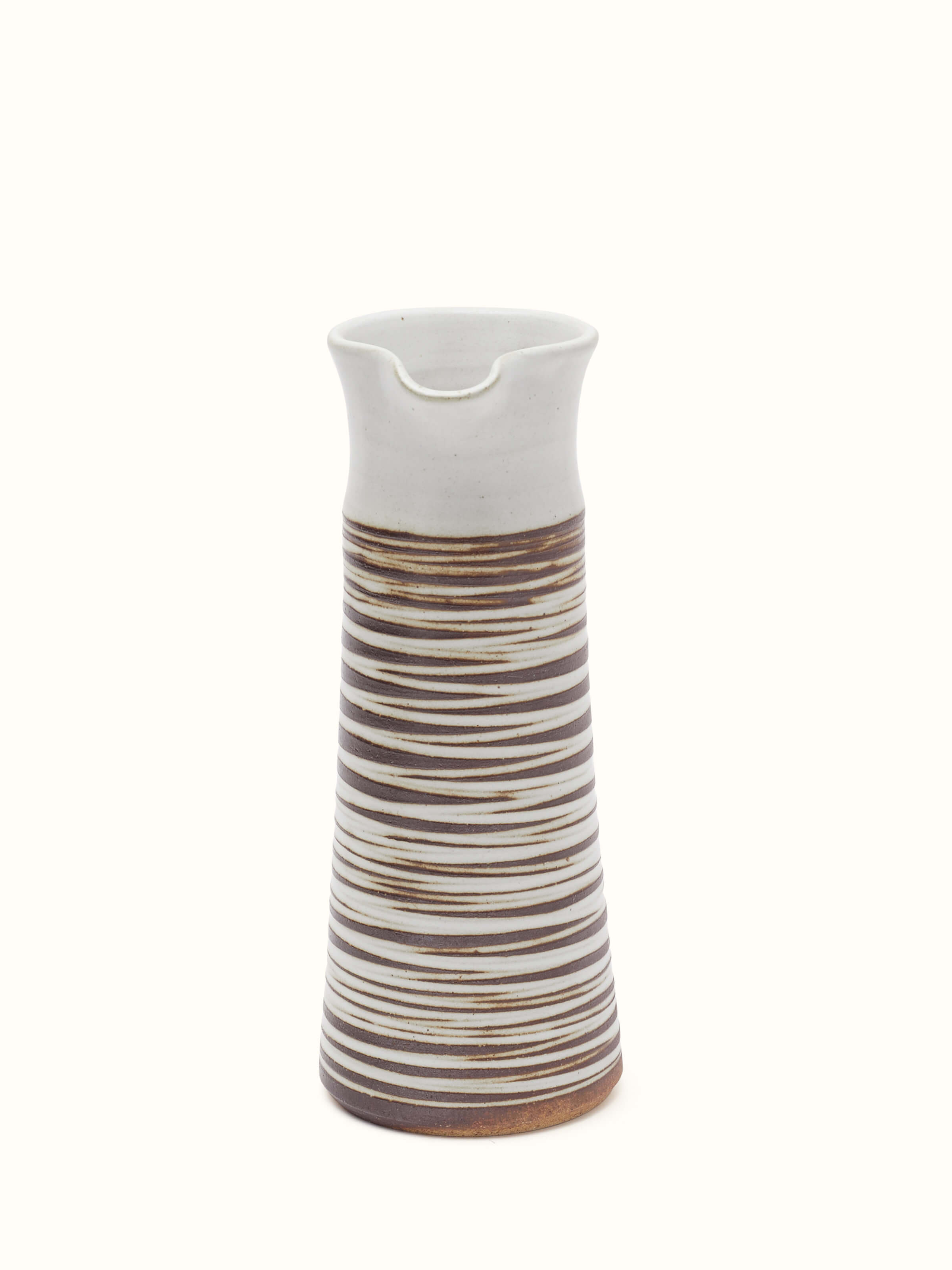 Studio pottery ceramic carafe with a focus on the elegant shape and textured glaze.