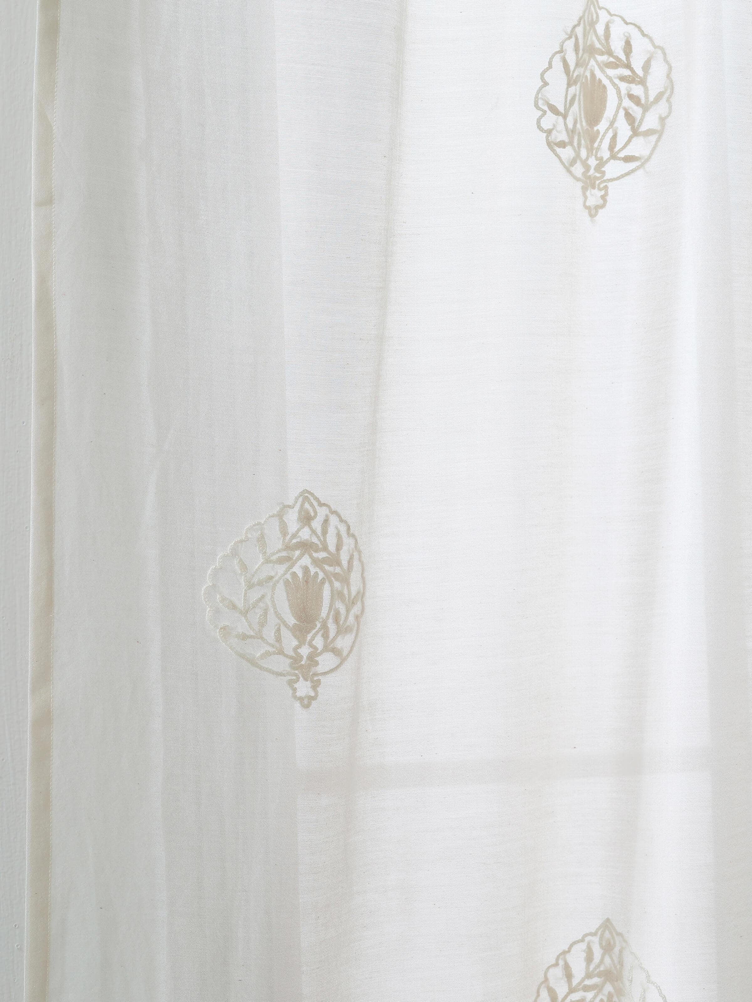 Perspective view of Razza ivory buti cotton silk crewel hand embroidered sheer curtain (9 ft) capturing the curtain’s full length and embroidery.